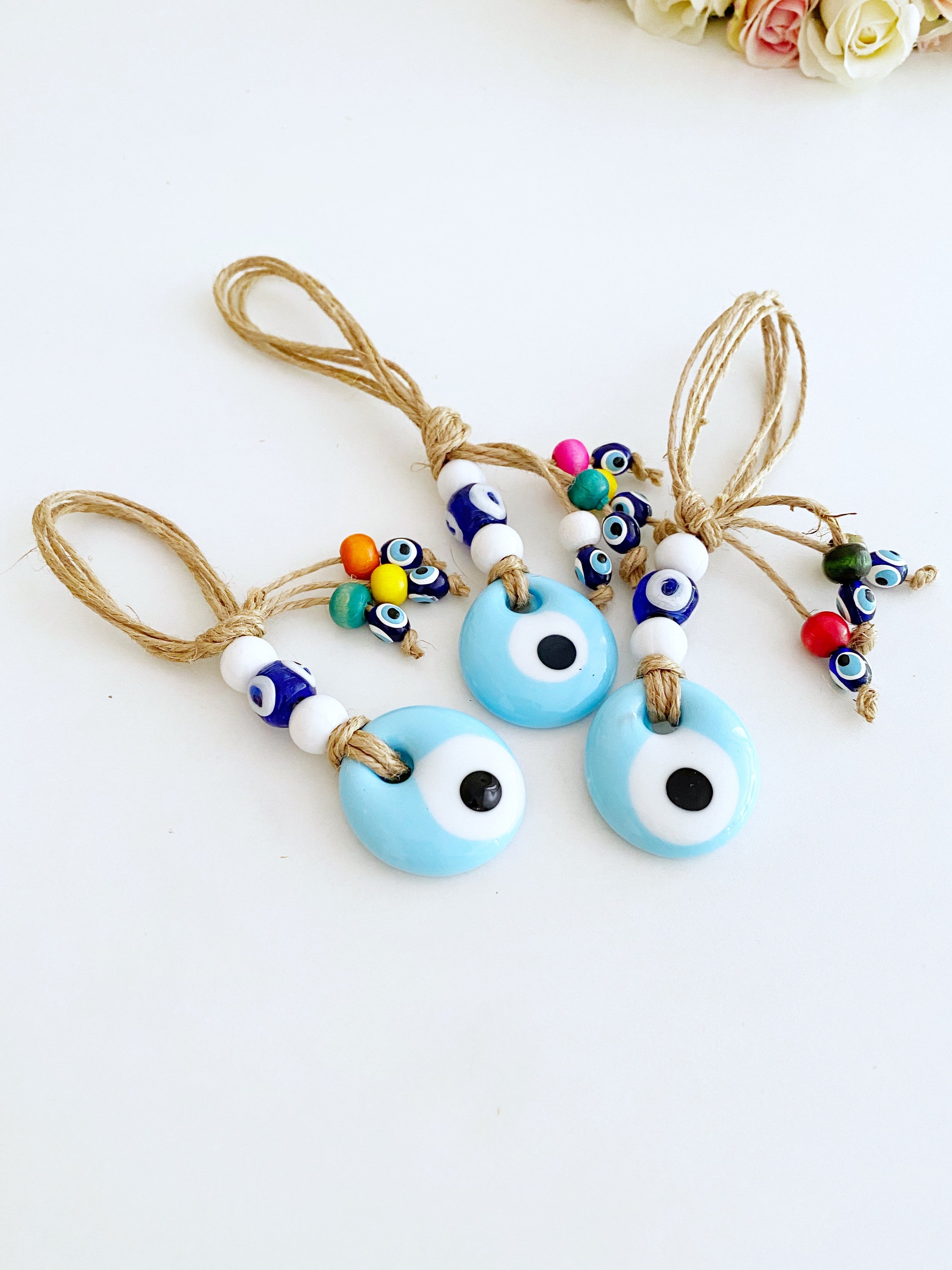 Handmade Lucky Evil Eye Bead charm for car rearview mirror, featuring a white evil eye bead and colorful glass beads.