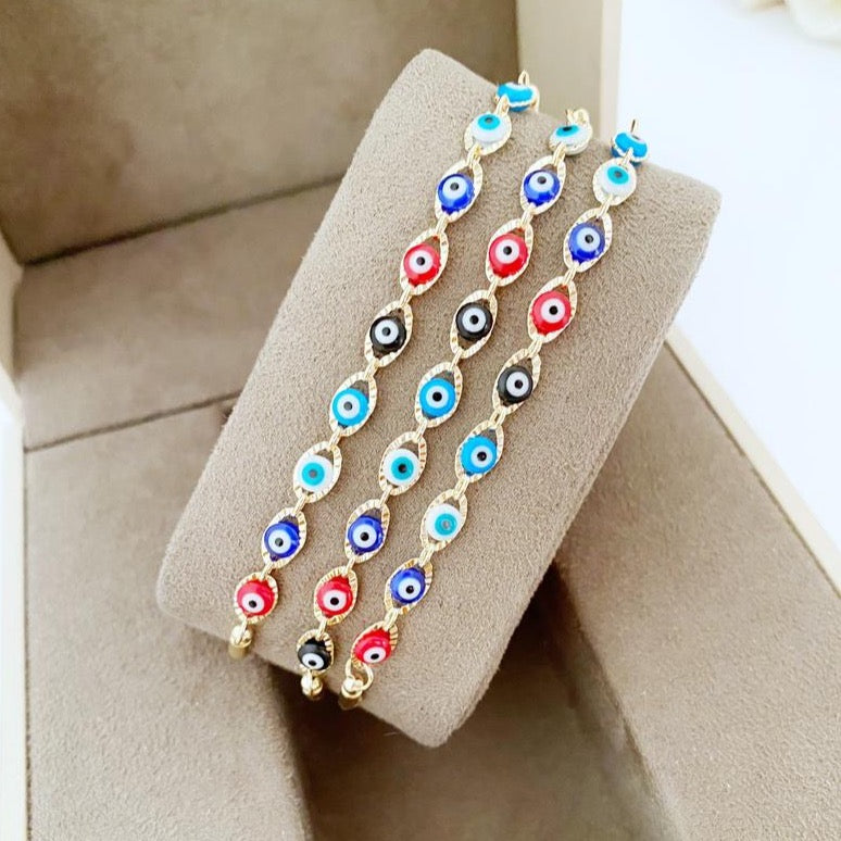 A multicolor adjustable Lucky Evil Eye Bracelet featuring tiny evil eye charms and gold accents, made from tarnish-resistant stainless steel.