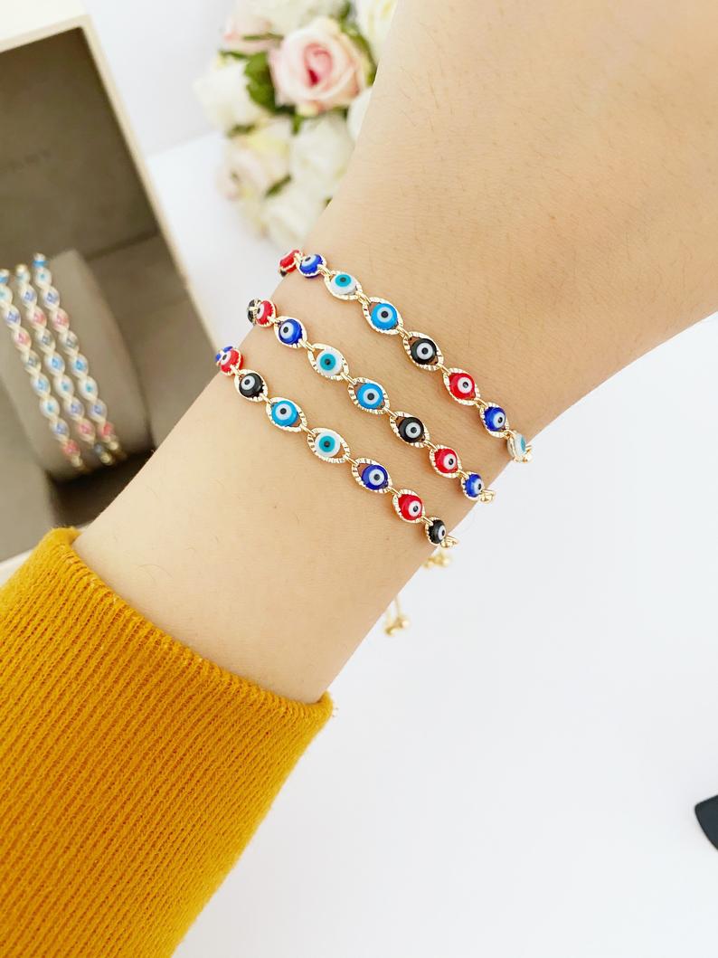 A multicolor adjustable Lucky Evil Eye Bracelet featuring tiny evil eye charms and gold accents, made from tarnish-resistant stainless steel.