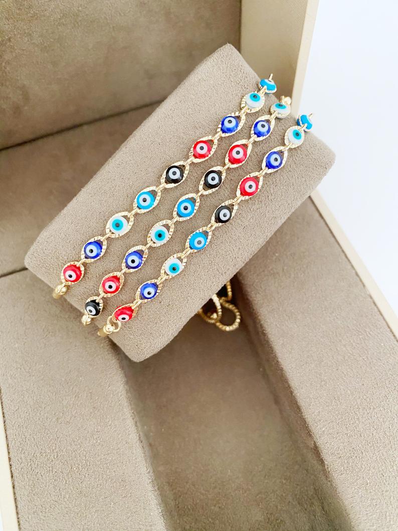 A multicolor adjustable Lucky Evil Eye Bracelet featuring tiny evil eye charms and gold accents, made from tarnish-resistant stainless steel.