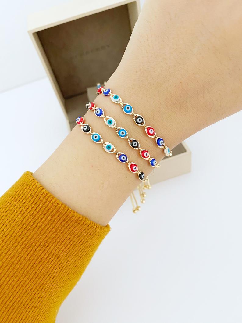 A multicolor adjustable Lucky Evil Eye Bracelet featuring tiny evil eye charms and gold accents, made from tarnish-resistant stainless steel.