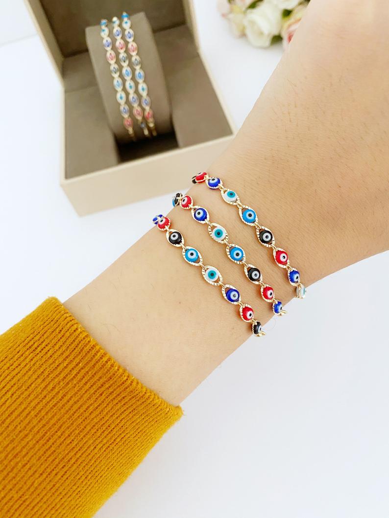 A multicolor adjustable Lucky Evil Eye Bracelet featuring tiny evil eye charms and gold accents, made from tarnish-resistant stainless steel.