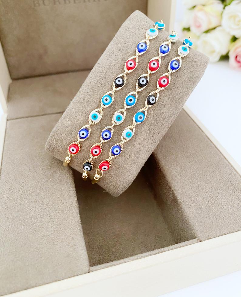 A multicolor adjustable Lucky Evil Eye Bracelet featuring tiny evil eye charms and gold accents, made from tarnish-resistant stainless steel.