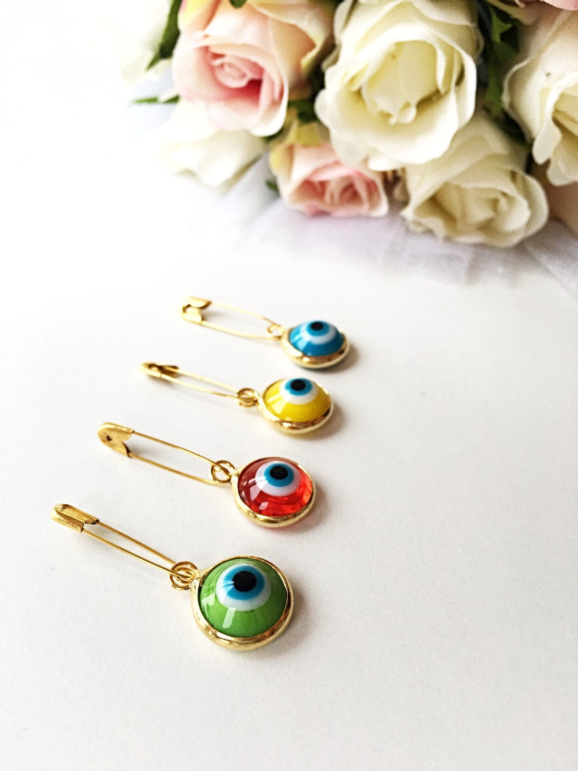 Gold plated lucky evil eye safety pin with colorful enamel, designed for baby protection.