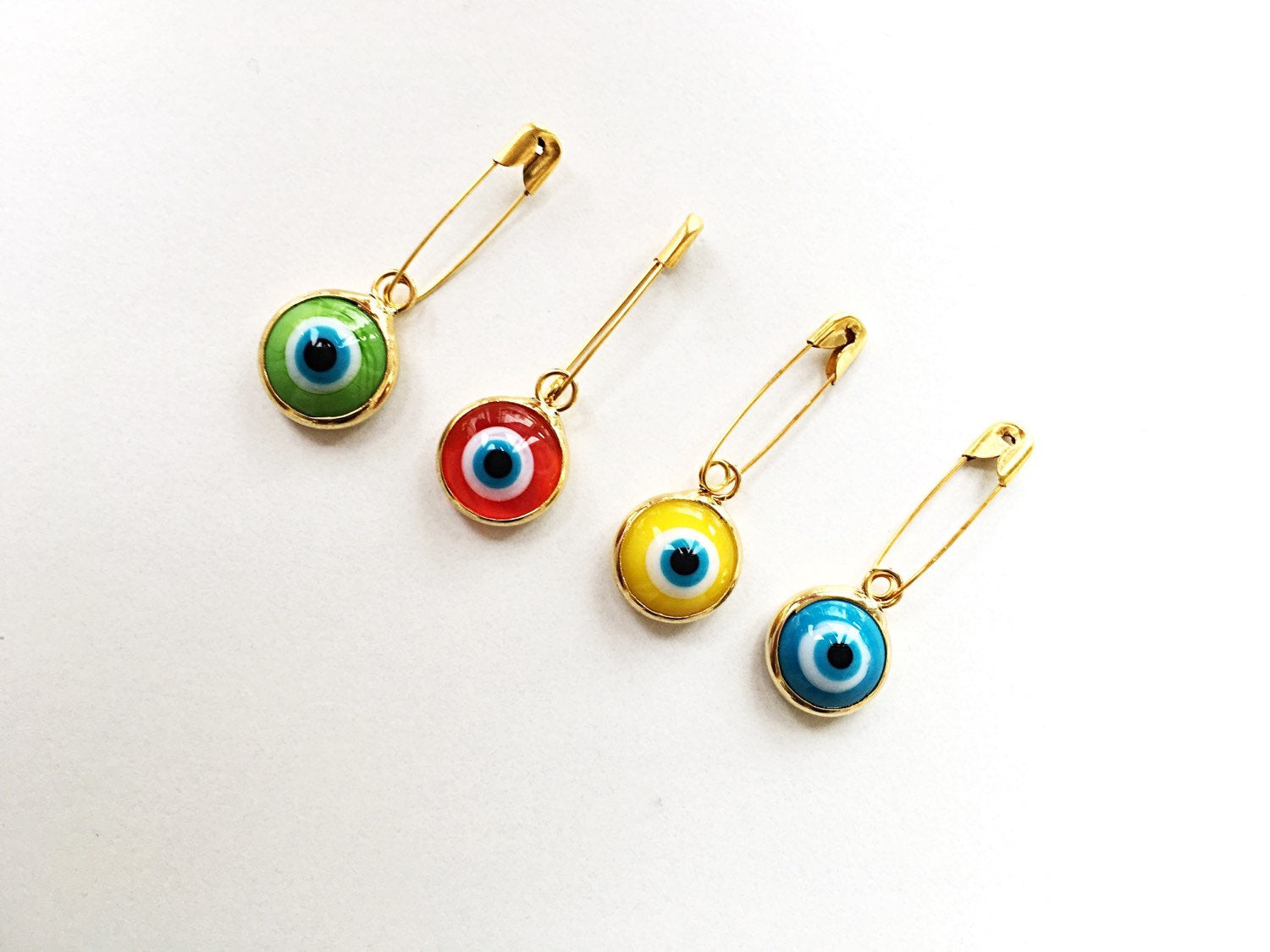 Gold plated lucky evil eye safety pin with colorful enamel, designed for baby protection.