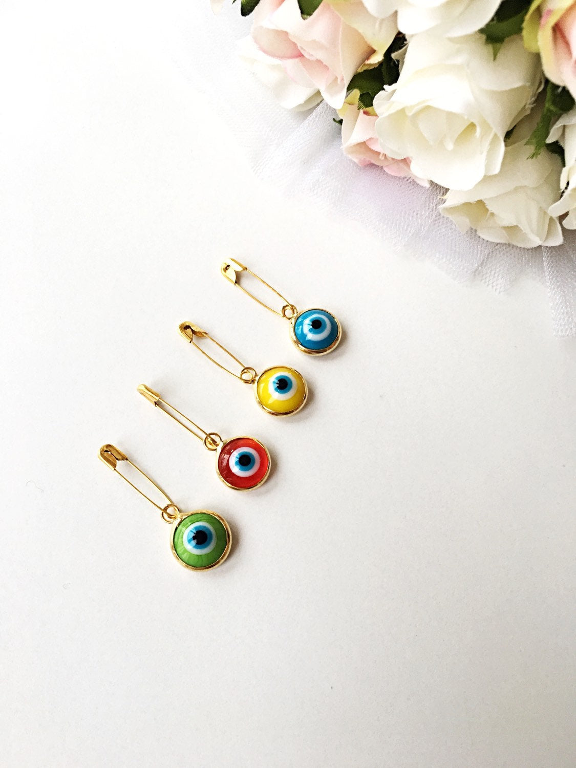 Gold plated lucky evil eye safety pin with colorful enamel, designed for baby protection.