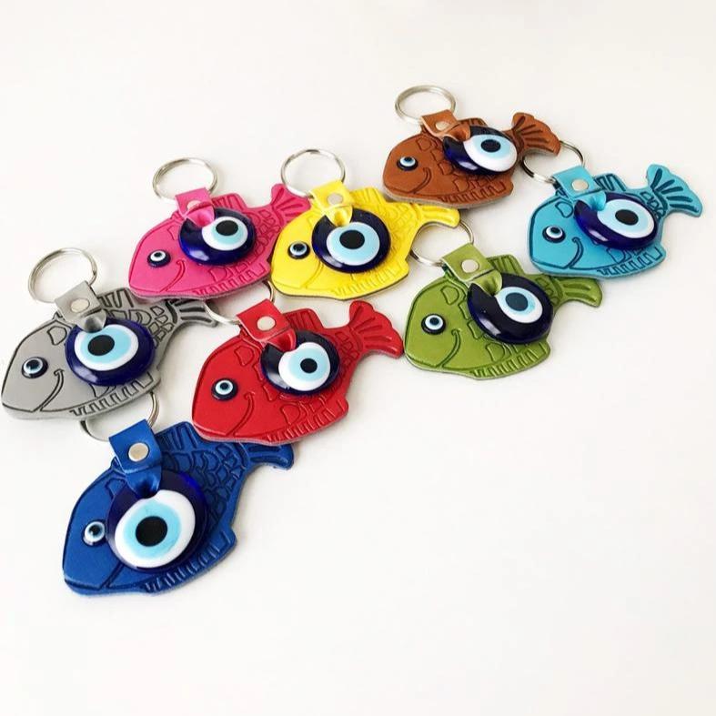 Lucky Fish Evil Eye Keychain featuring a suede leather design with glass evil eye beads in various colors.