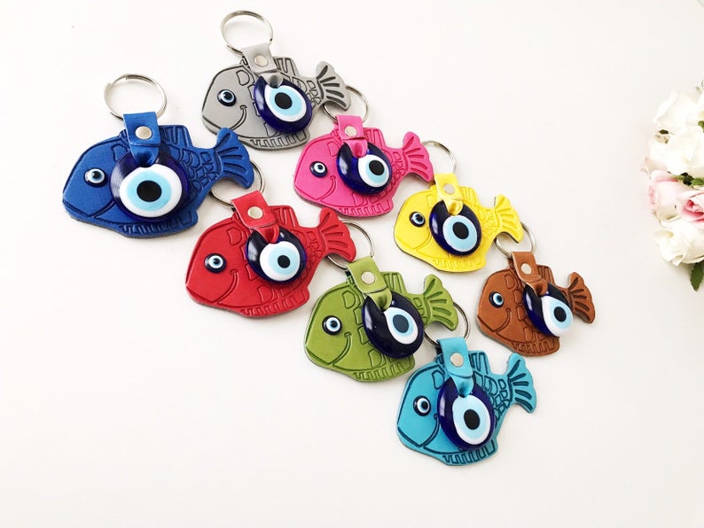 Lucky Fish Evil Eye Keychain featuring a suede leather design with glass evil eye beads in various colors.