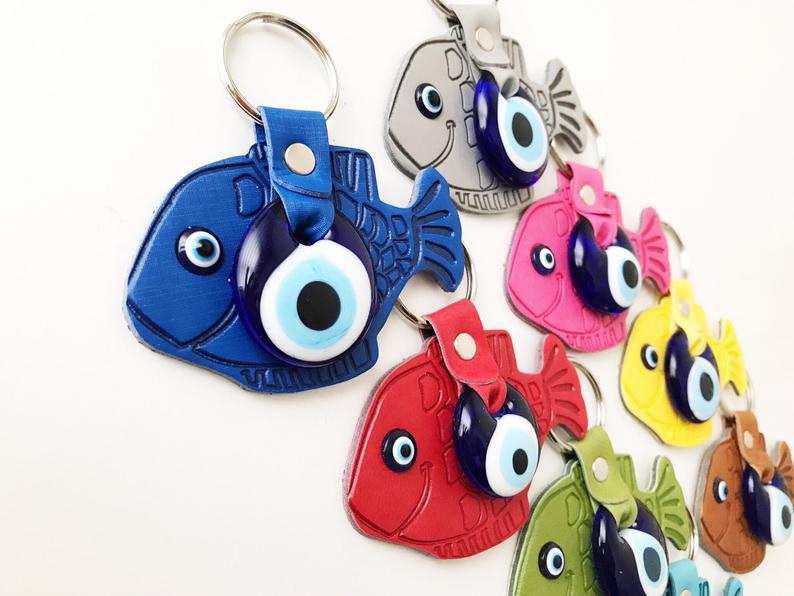 Lucky Fish Evil Eye Keychain featuring a suede leather design with glass evil eye beads in various colors.