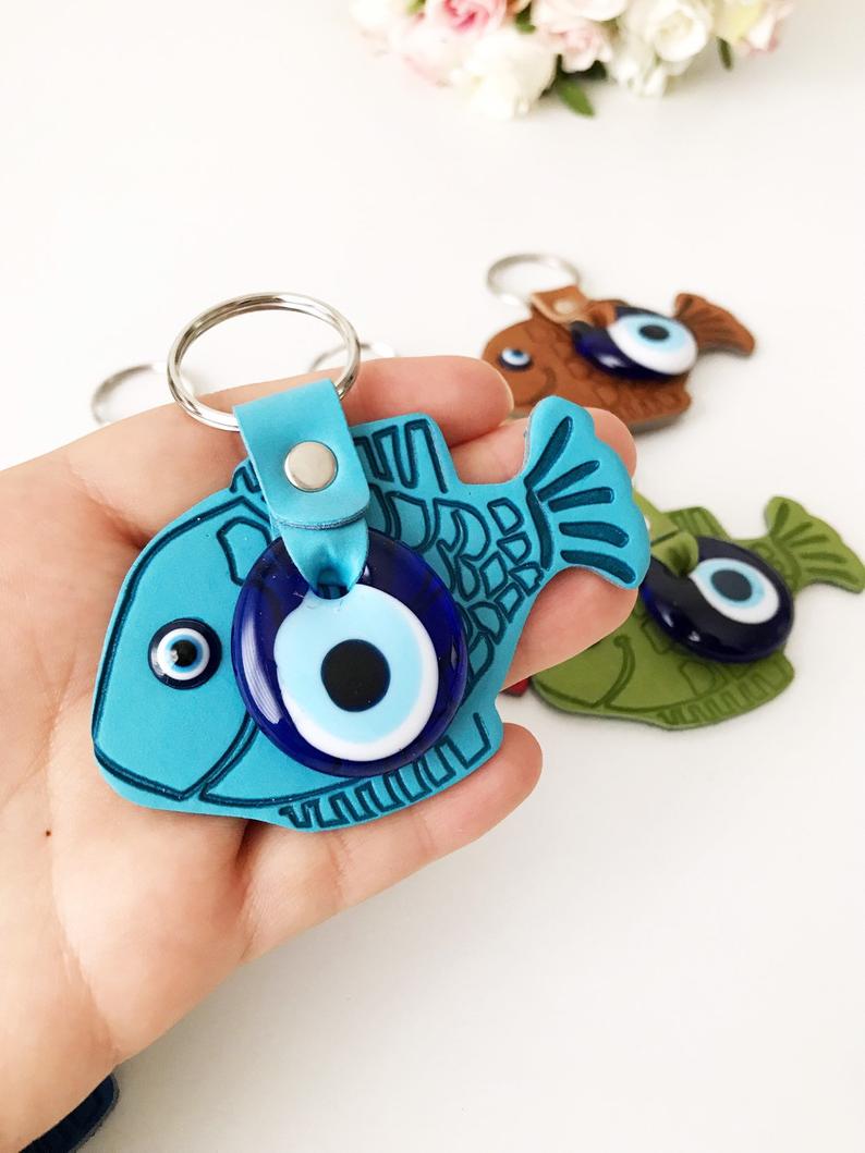 Lucky Fish Evil Eye Keychain featuring a suede leather design with glass evil eye beads in various colors.