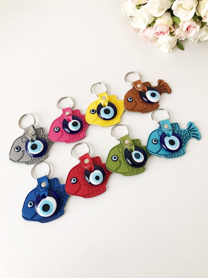 Lucky Fish Evil Eye Keychain featuring a suede leather design with glass evil eye beads in various colors.