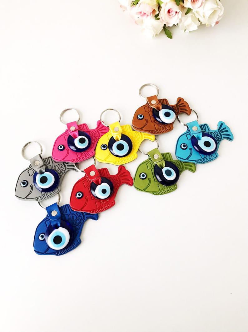 Lucky Fish Evil Eye Keychain featuring a suede leather design with glass evil eye beads in various colors.