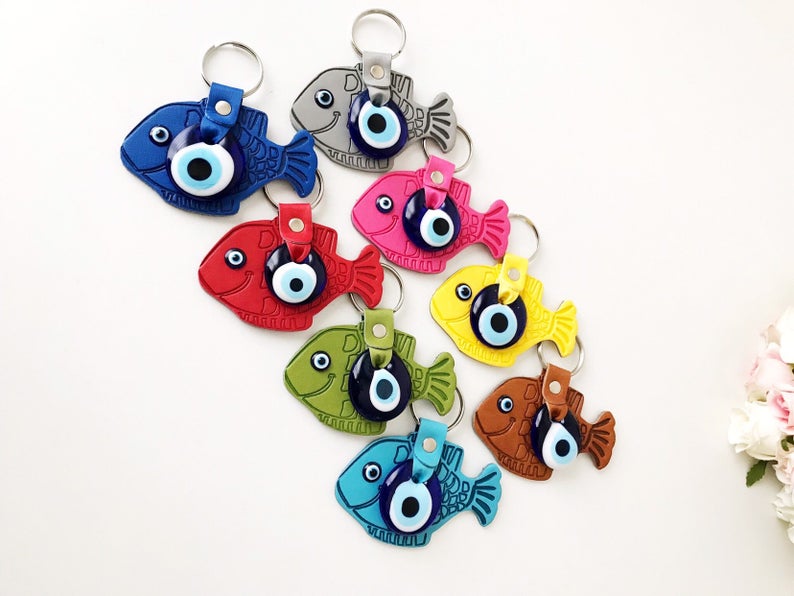 Lucky Fish Evil Eye Keychain featuring a suede leather design with glass evil eye beads in various colors.