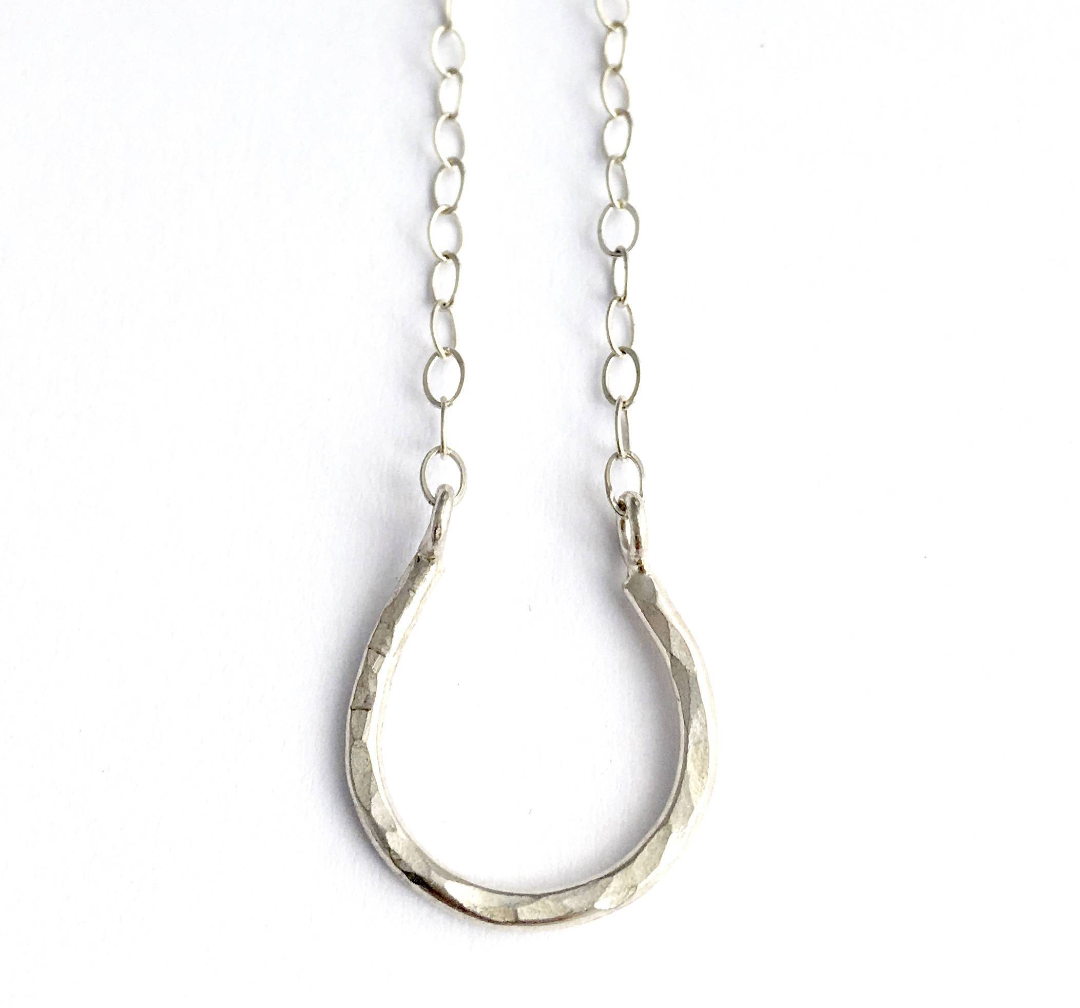 A delicate Lucky Horseshoe Charm Necklace featuring a hammered horseshoe pendant in sterling silver, yellow gold fill, or two-toned finish.