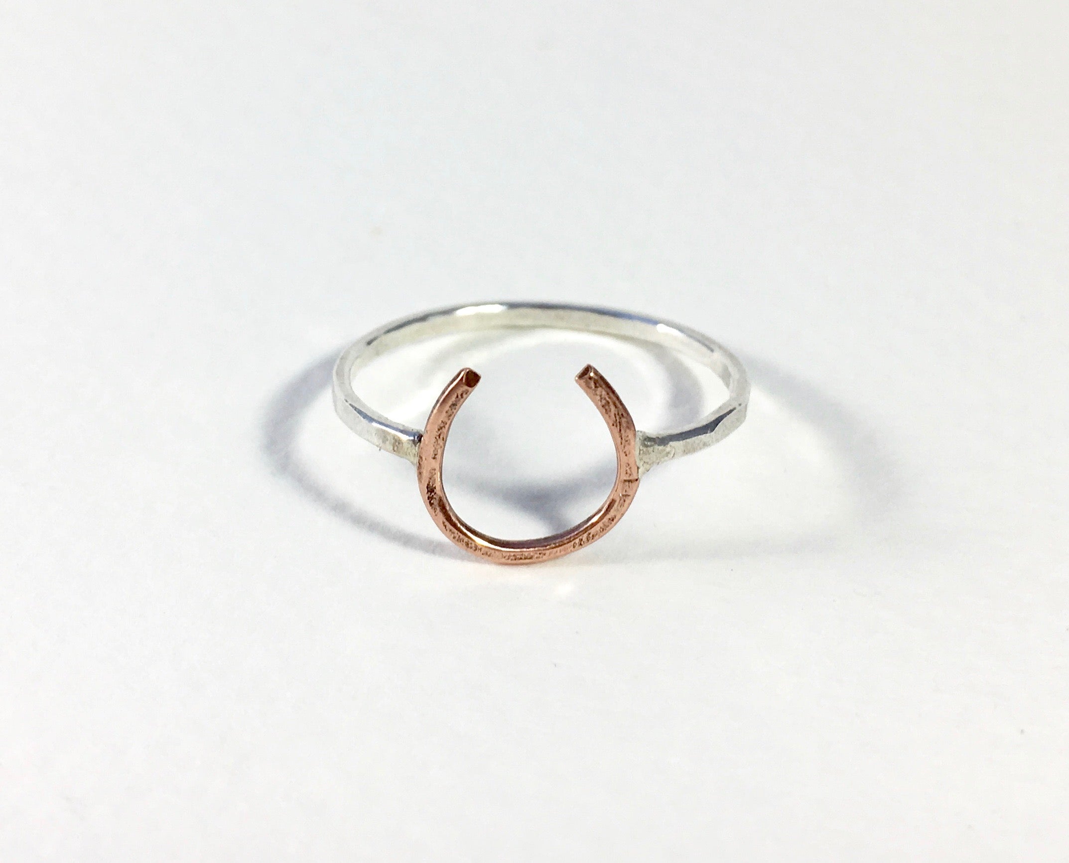 A handmade Lucky Horseshoe Ring crafted from 18 gauge wire, featuring a unique horseshoe design symbolizing good luck.