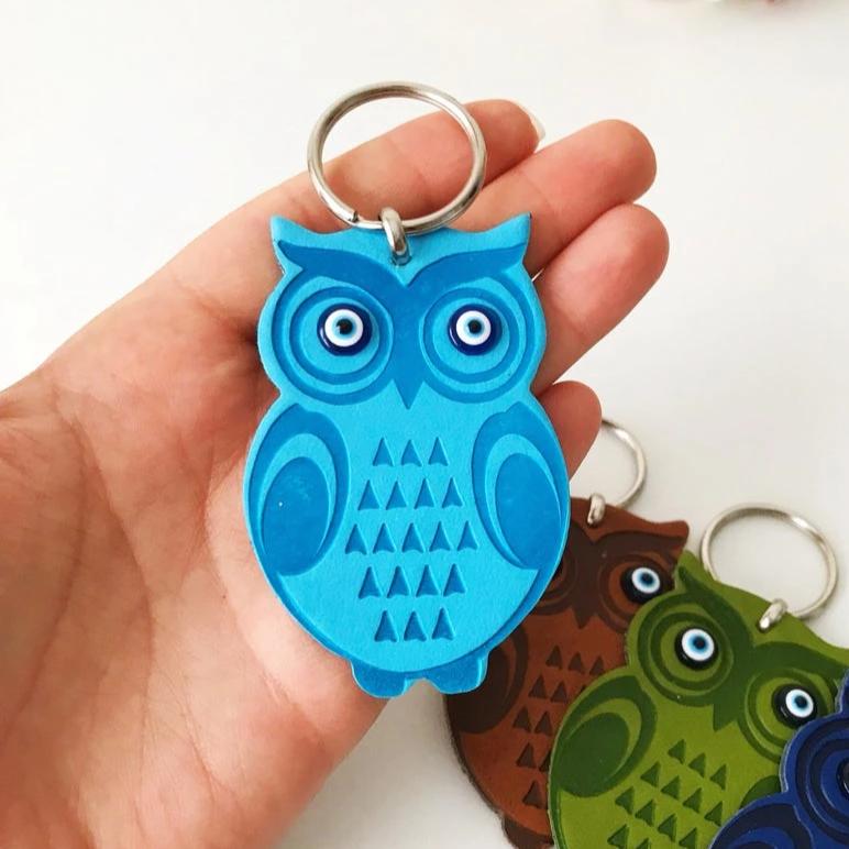 Lucky owl keychain featuring evil eye protection, made of suede leather with colorful resin beads.