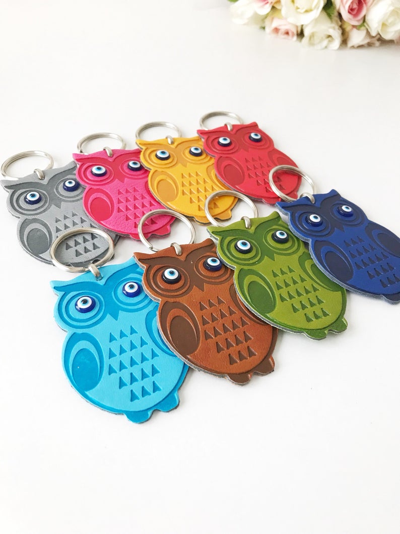 Lucky owl keychain featuring evil eye protection, made of suede leather with colorful resin beads.