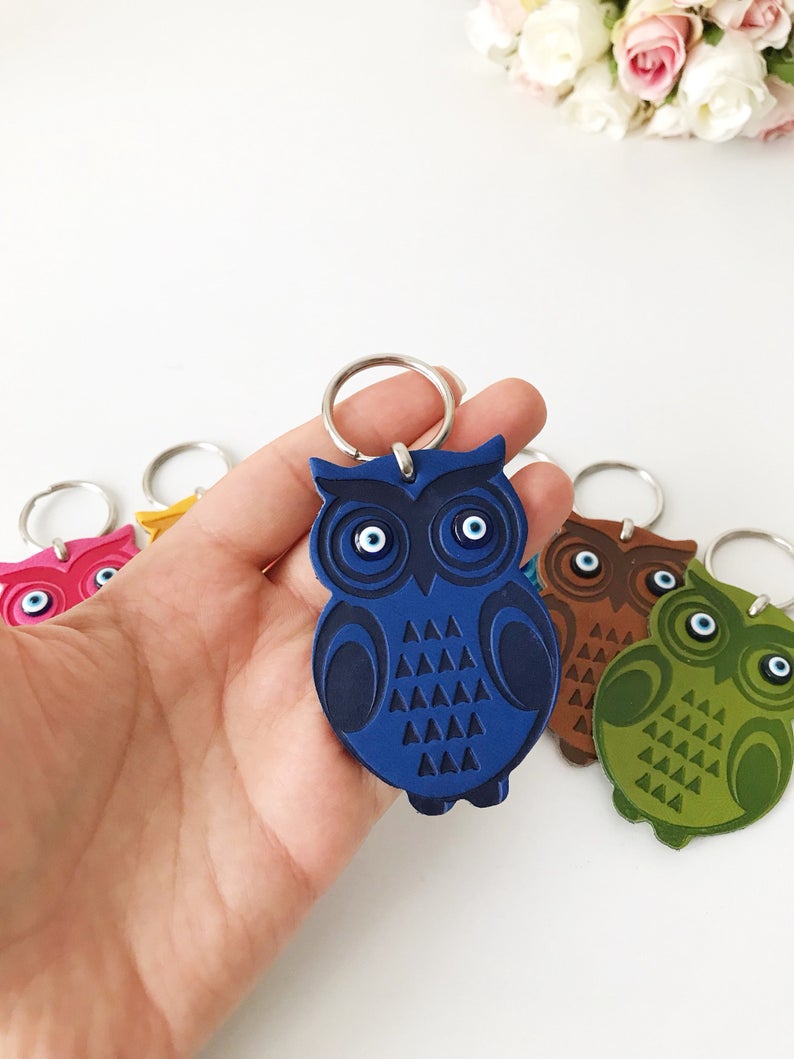 Lucky owl keychain featuring evil eye protection, made of suede leather with colorful resin beads.