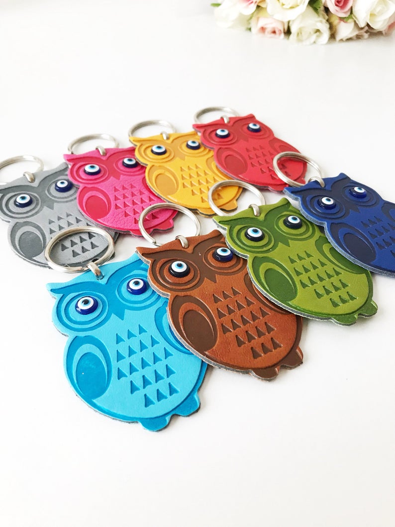 Lucky owl keychain featuring evil eye protection, made of suede leather with colorful resin beads.