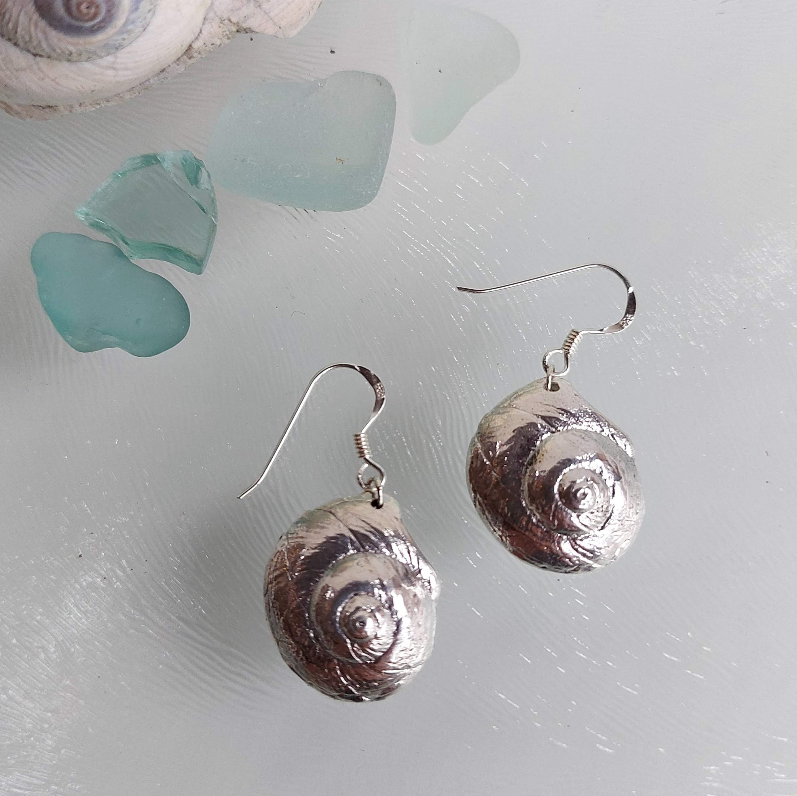 Luna Moon Snail Shell Earrings made from sterling silver, showcasing intricate details of the moon snail shell design.