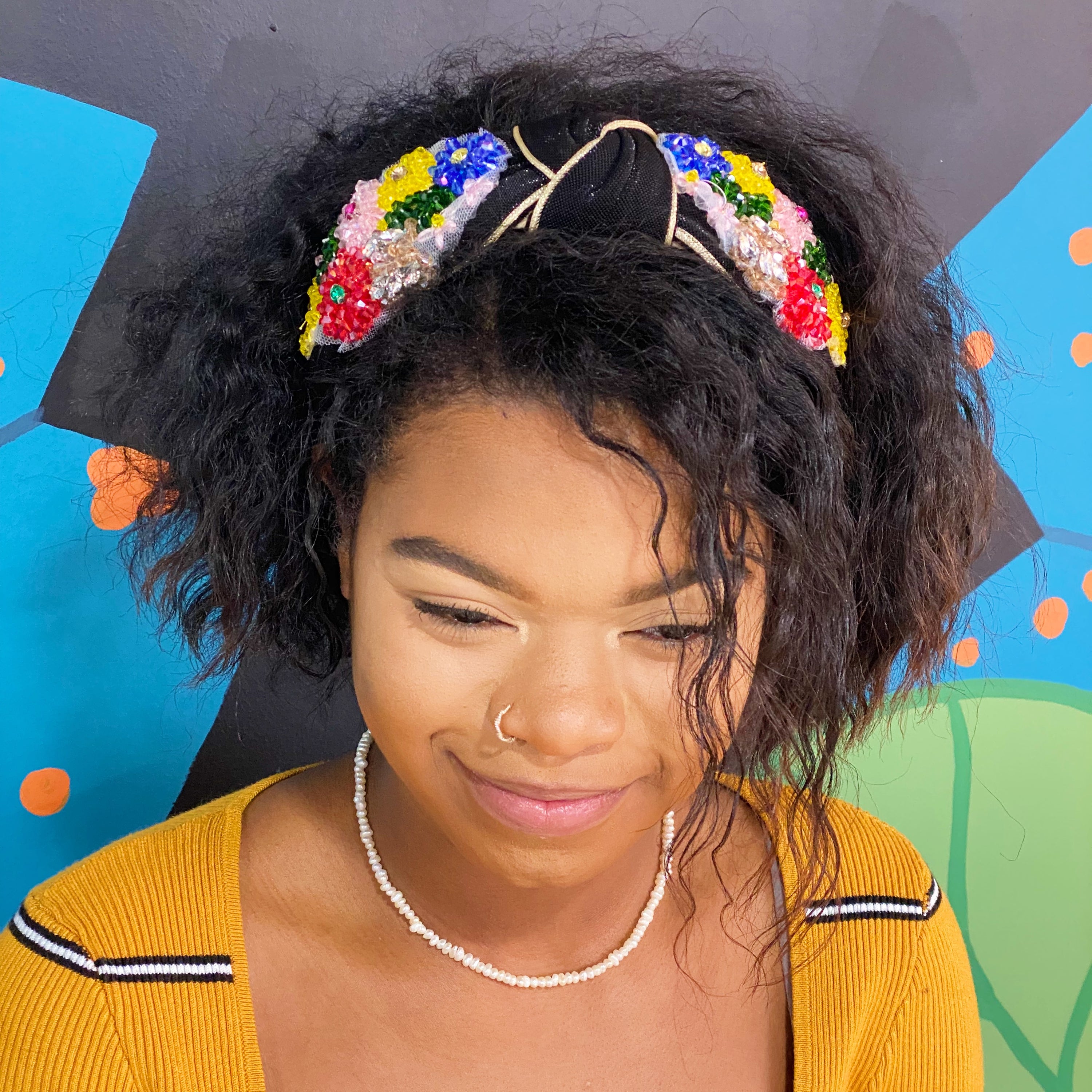 Luxe Flower Bead Headband featuring black shimmer fabric, gold trim, and intricate beaded flowers for a stylish look.