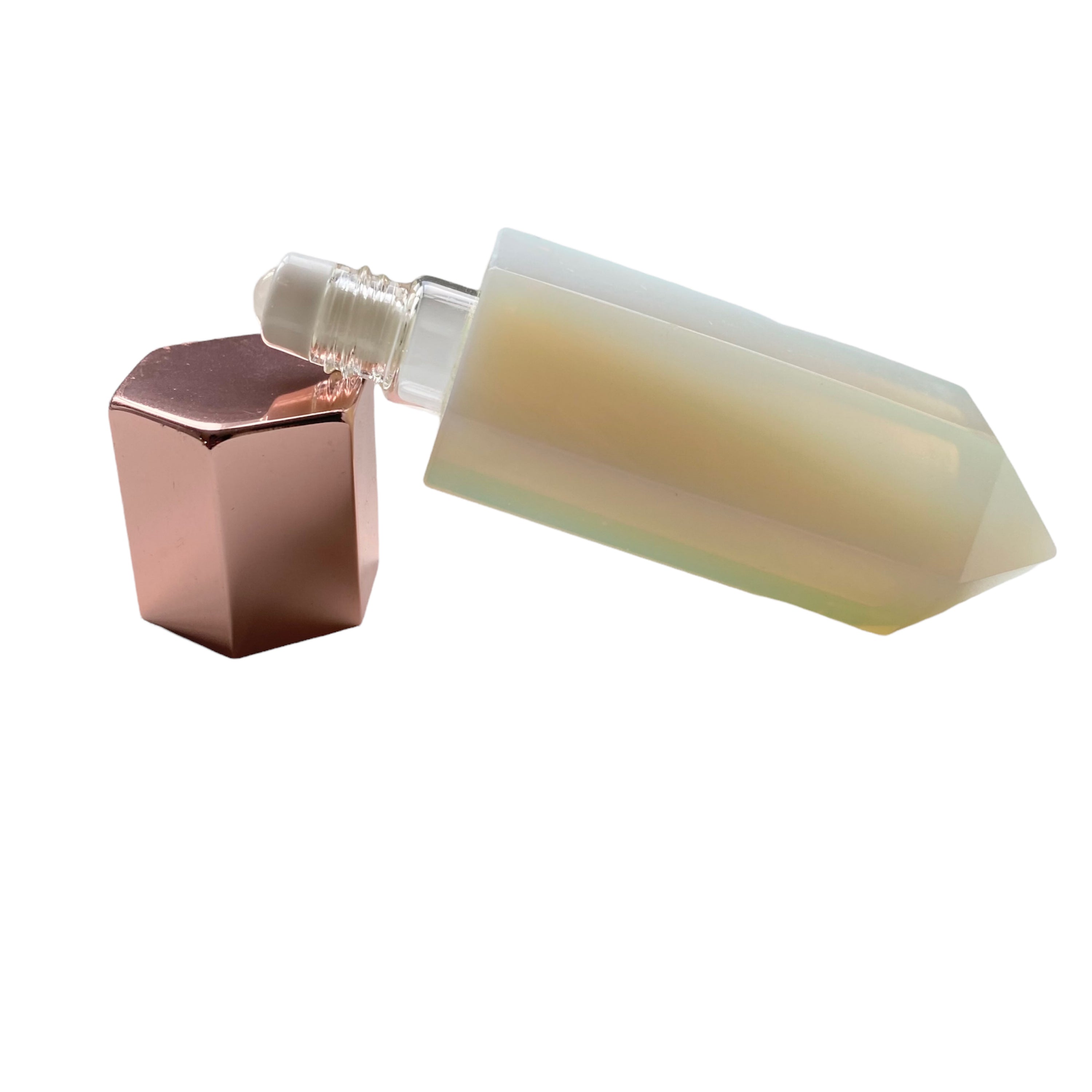 A luxurious gemstone perfume bottle featuring a stunning gemstone point roller design, available in Opalite, Amethyst, Rose Quartz, and Green Fluorite.