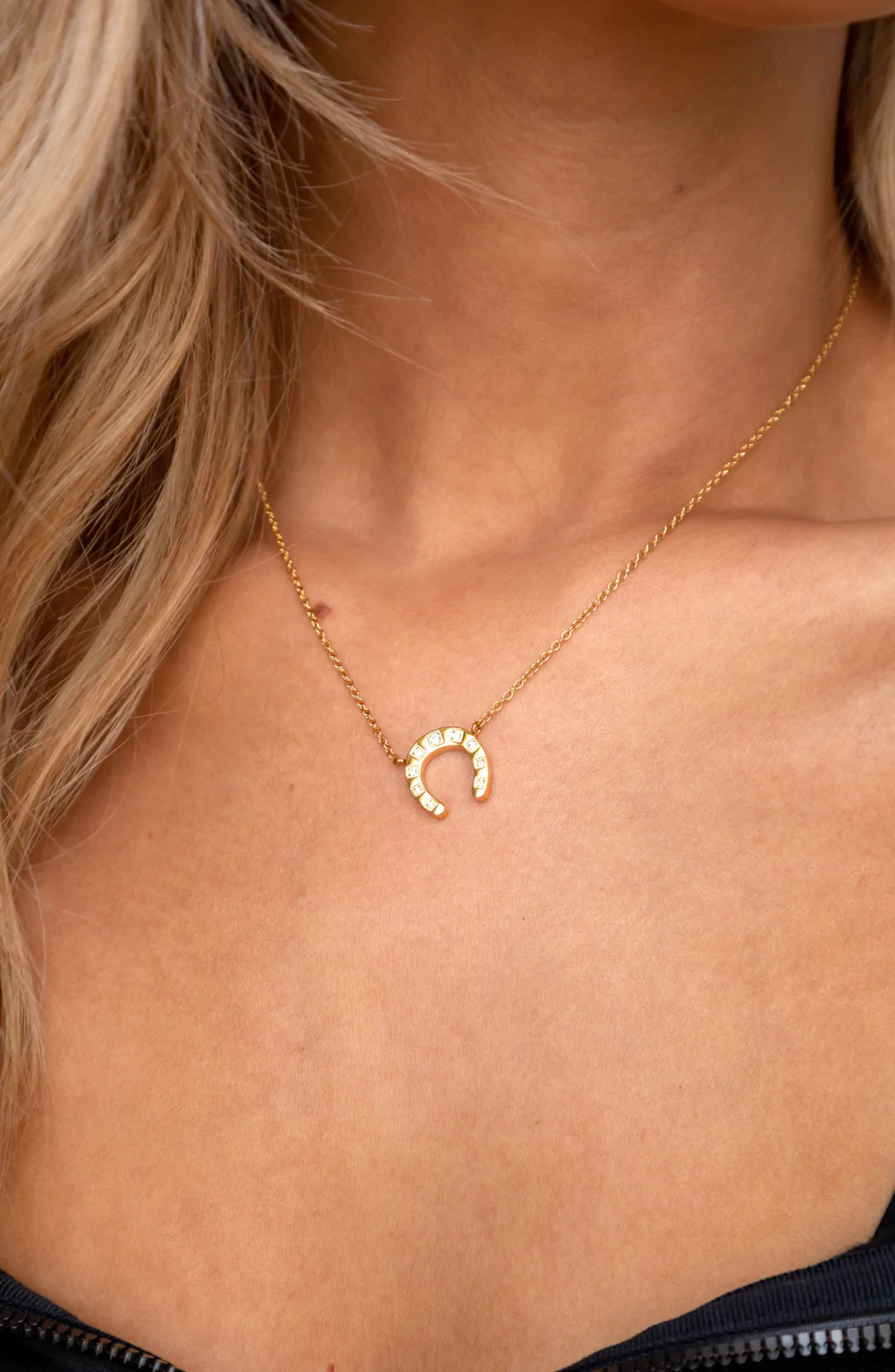 Maddox Horseshoe Necklace featuring a classic horseshoe design, 18K gold plated over sterling silver, displayed elegantly.