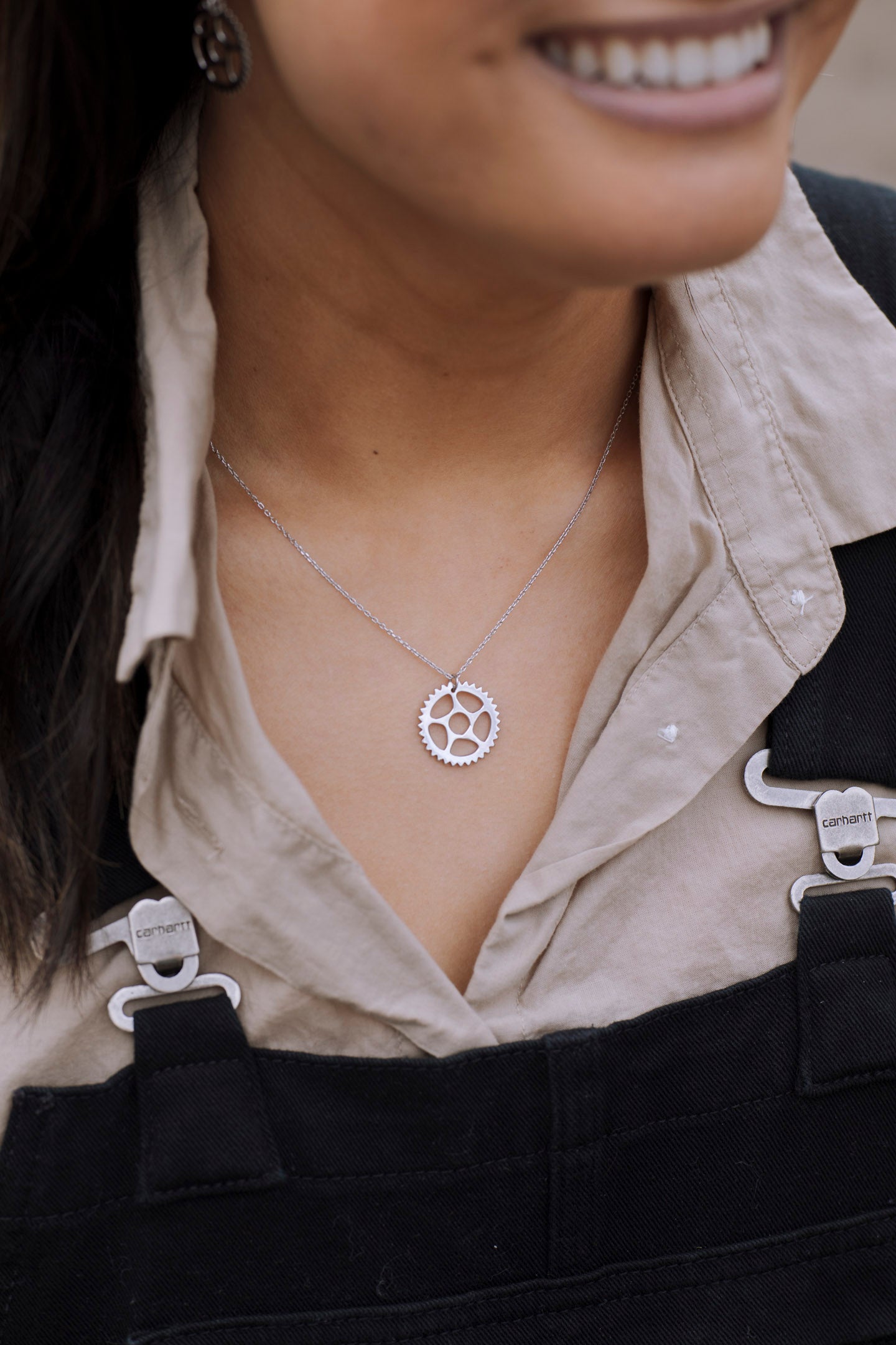 Maeve Bike Chain Ring Necklace in sterling silver with three plated finishes, showcasing a unique bike chain design.