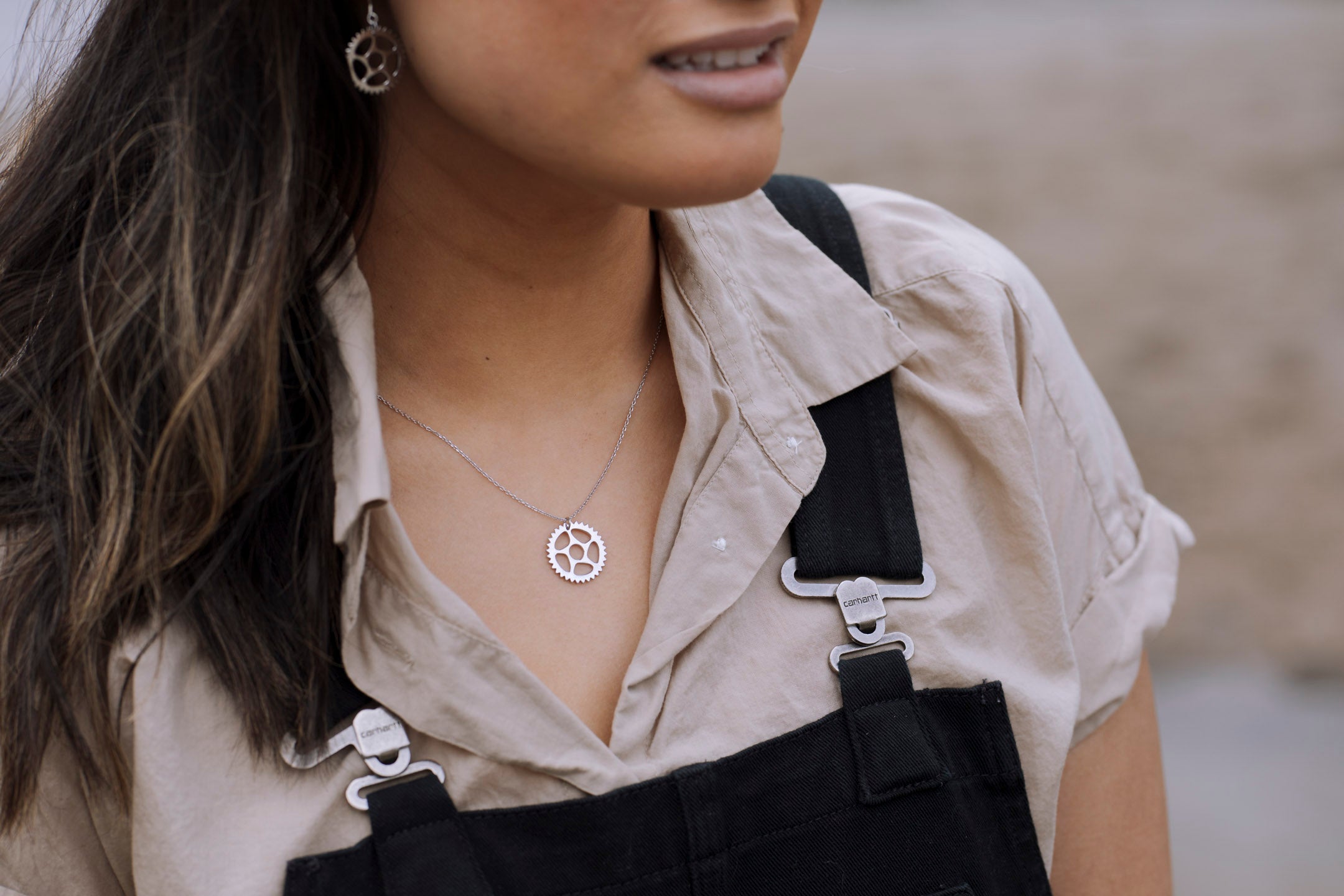 Maeve Bike Chain Ring Necklace in sterling silver with three plated finishes, showcasing a unique bike chain design.