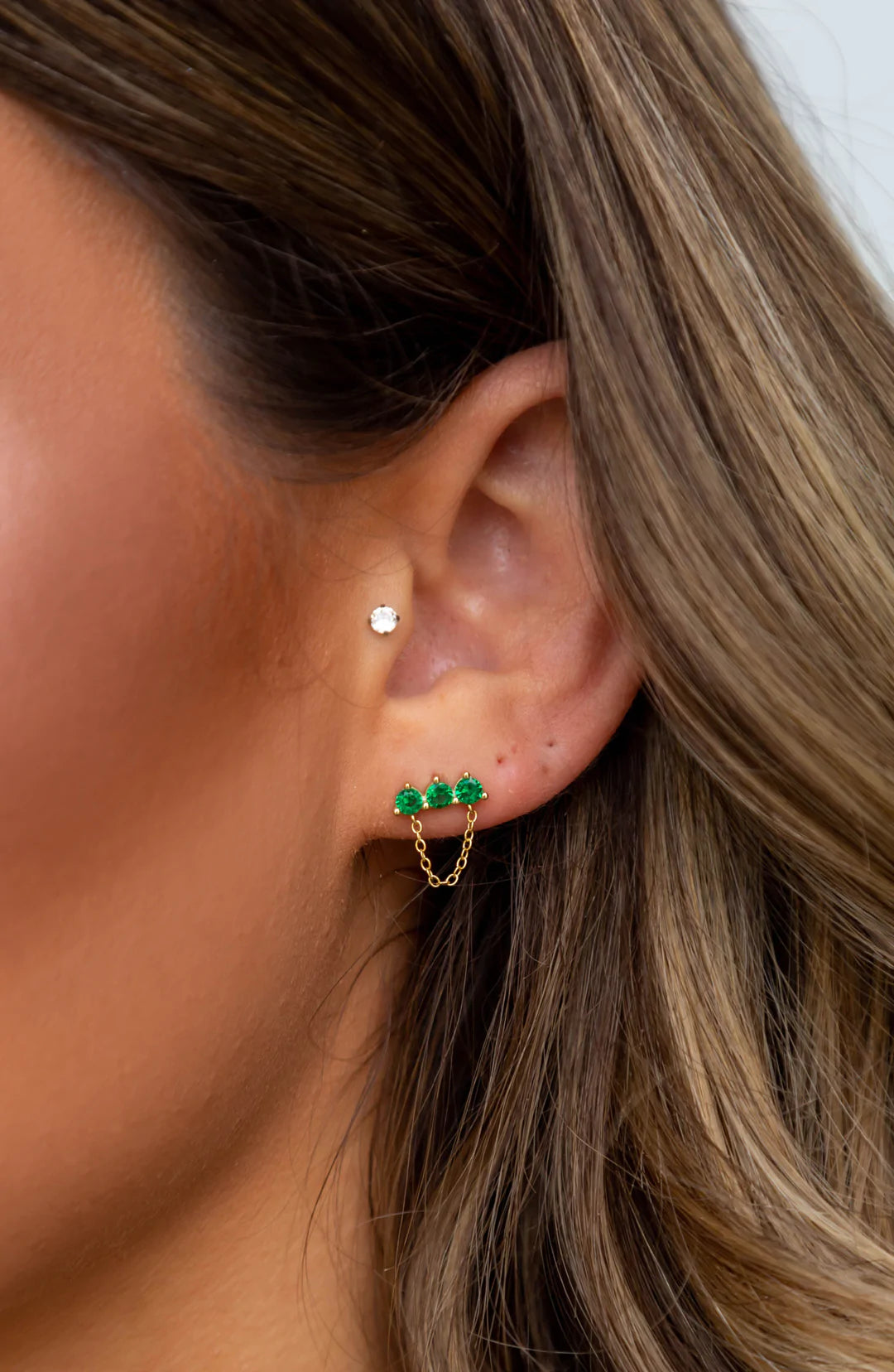 Magda Emerald Chain Studs featuring emerald cz stones and a delicate chain design, elegantly plated in 18k gold.