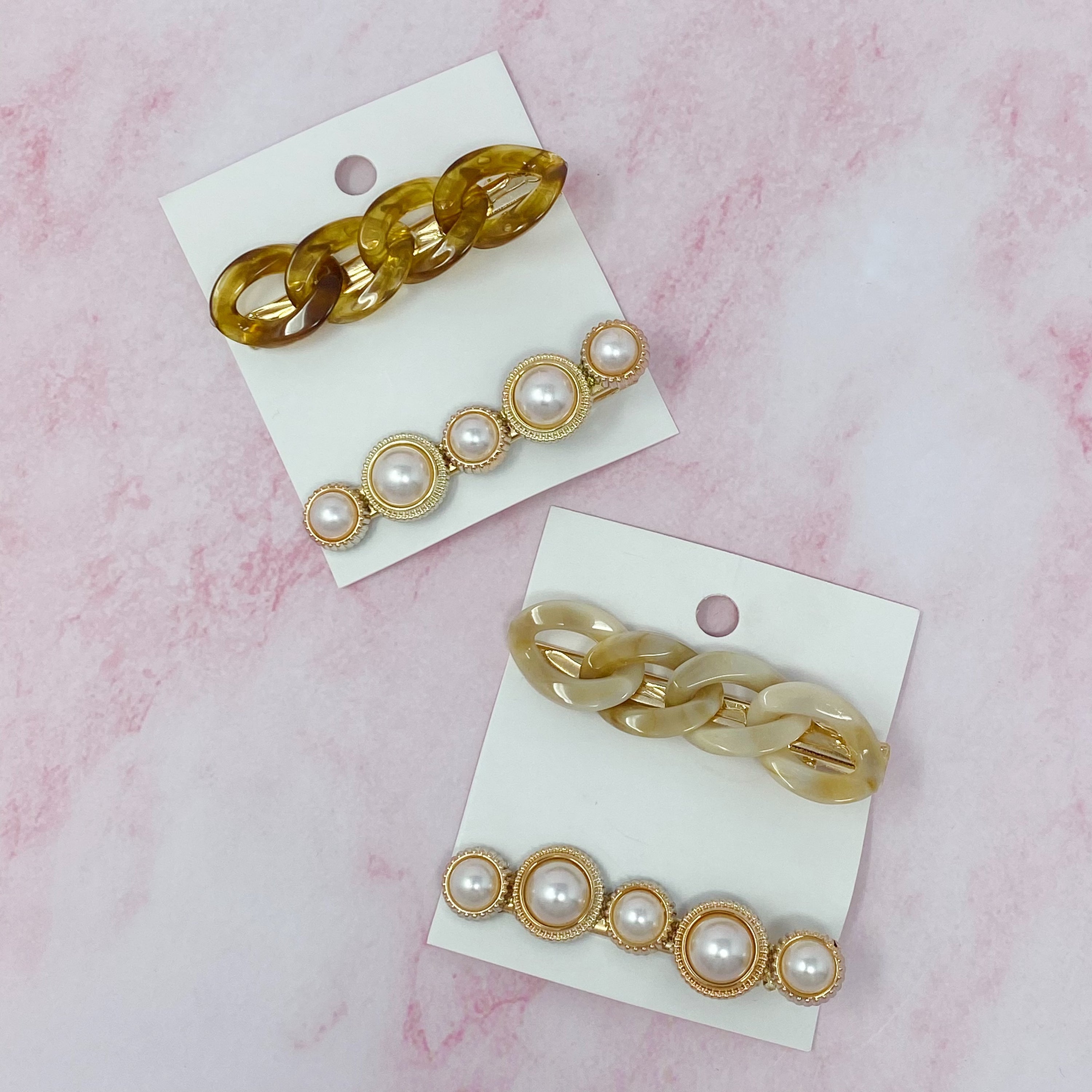 A stylish Marble Chain and Pearl Hair Clip Set featuring two elegant clips with neutral marble chains and pearl accents.