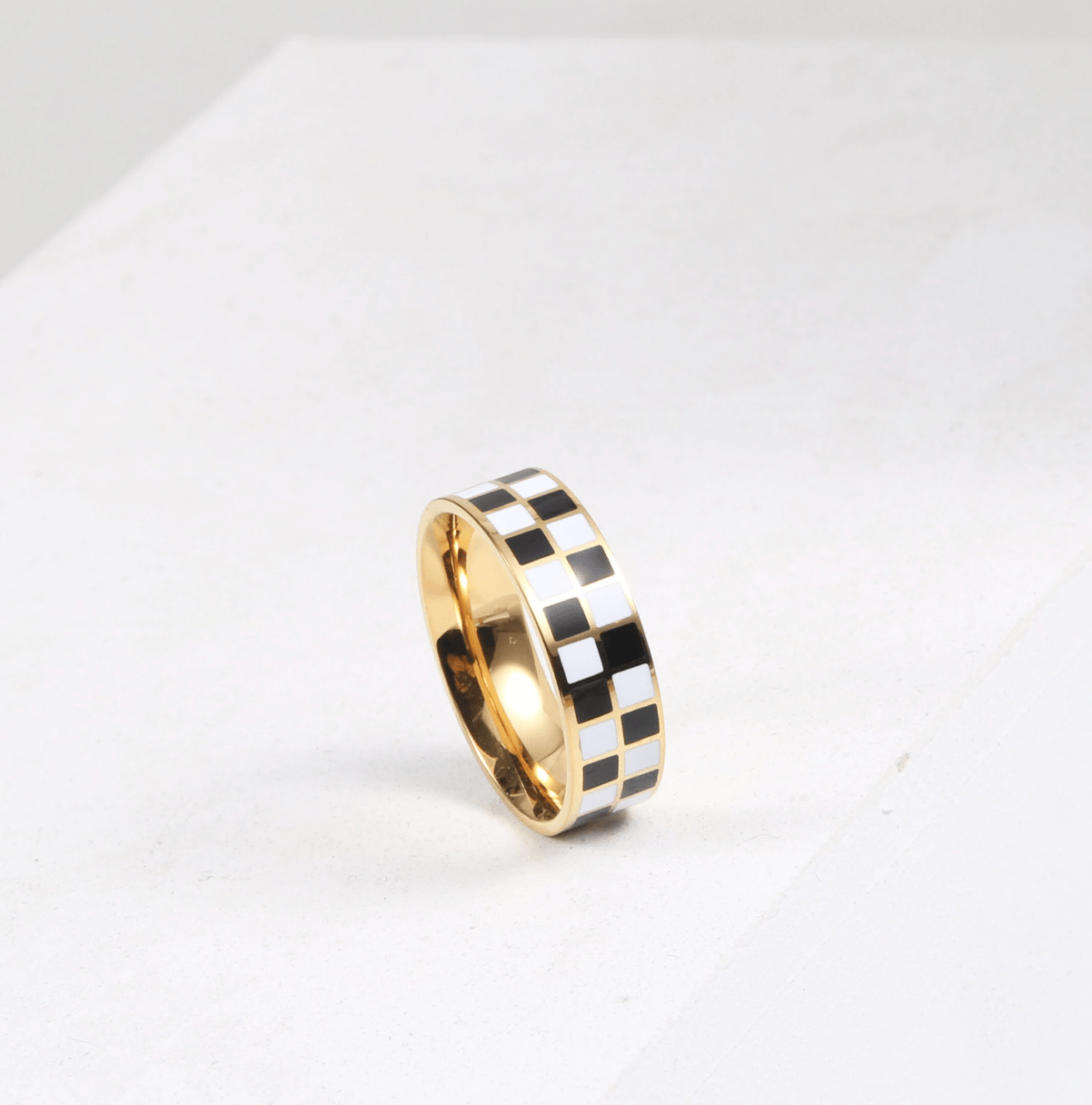 Margaux Black and White Karo Block Band featuring a classic check-board design in stainless steel with 18Kt yellow gold coating.