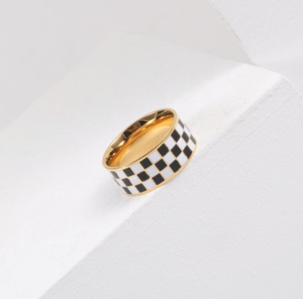 Margaux Black and White Karo Block Band featuring a classic check-board design in stainless steel with 18Kt yellow gold coating.