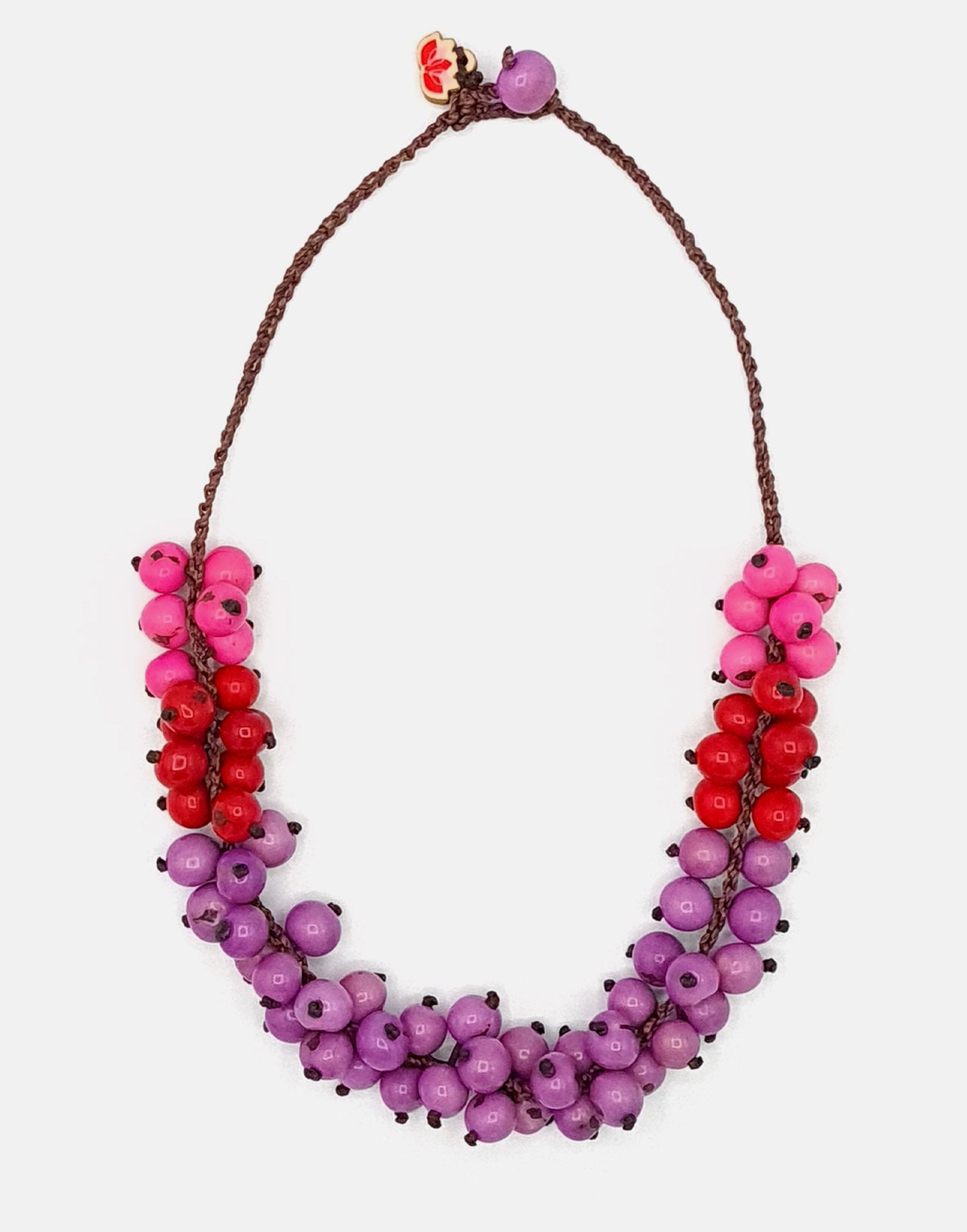 Maria Acai Crochet Necklace in Pink featuring a crocheted chain and acai seeds, showcasing a unique and eco-friendly design.