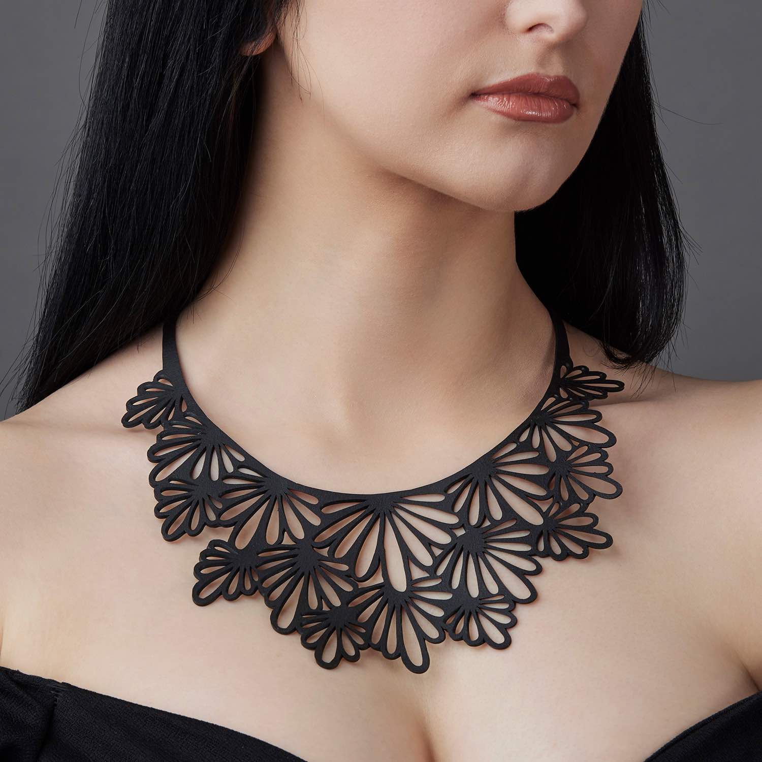 A vibrant Marigold Statement Recycled Rubber Necklace handcrafted from reclaimed tyre inner tubes, showcasing unique textures and patterns.