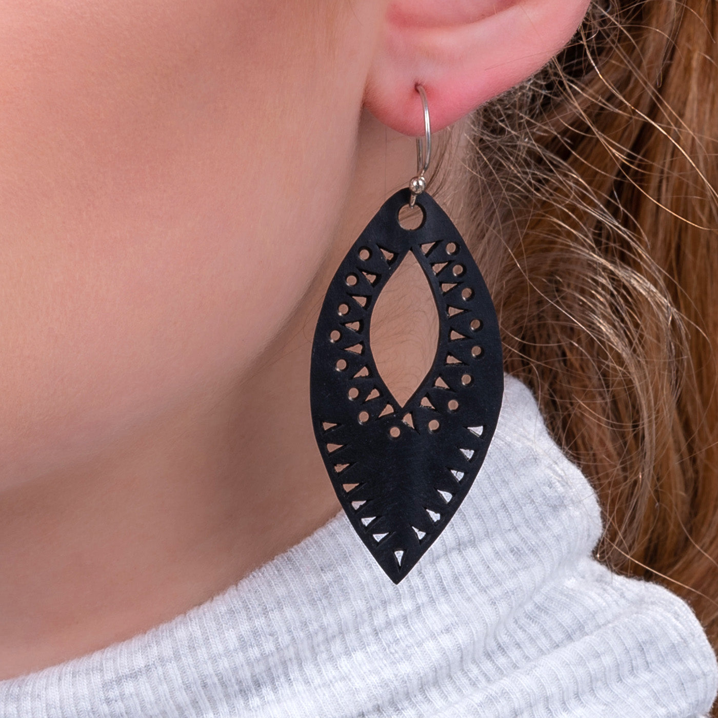 A pair of Marquise Intricate Recycled Rubber Earrings, showcasing unique designs crafted from reclaimed inner tubes with sterling silver hooks.