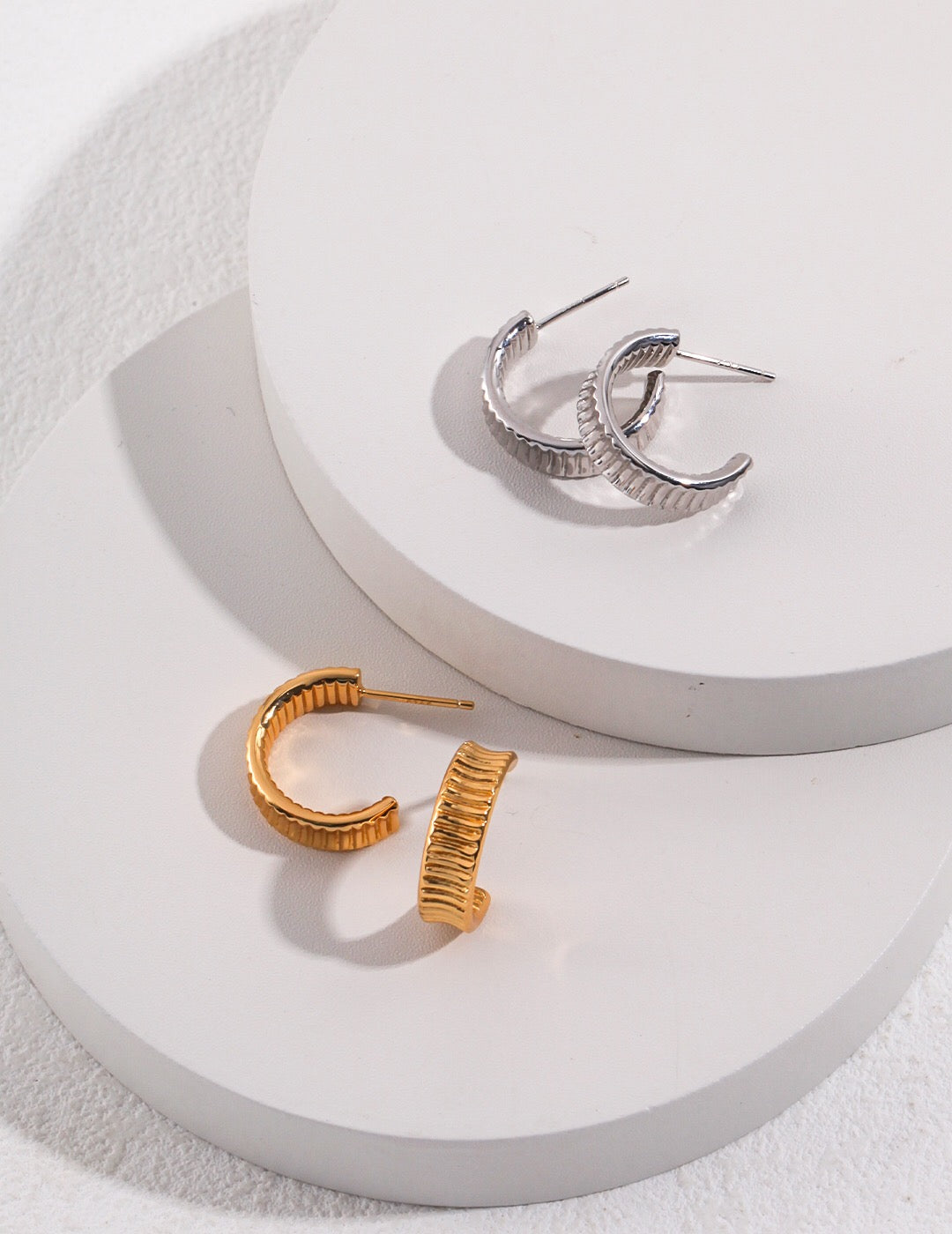 A pair of Medium Chunky Frill Hoop Earrings made from sterling silver and gold vermeil, showcasing a unique frill design.