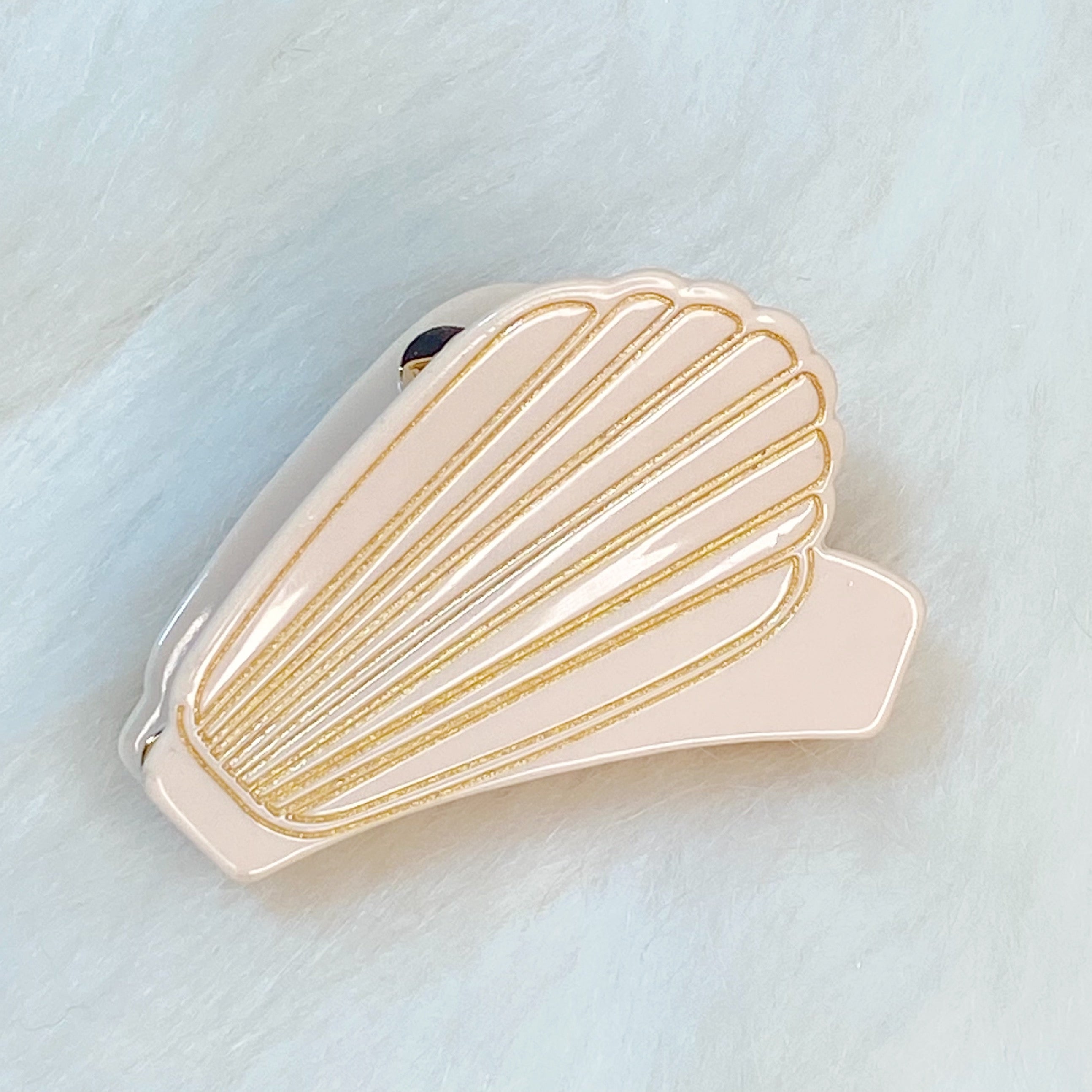 A stylish Mermaid Hair Claw with a shell-like design and gold tone hardware, perfect for summer hairstyles.