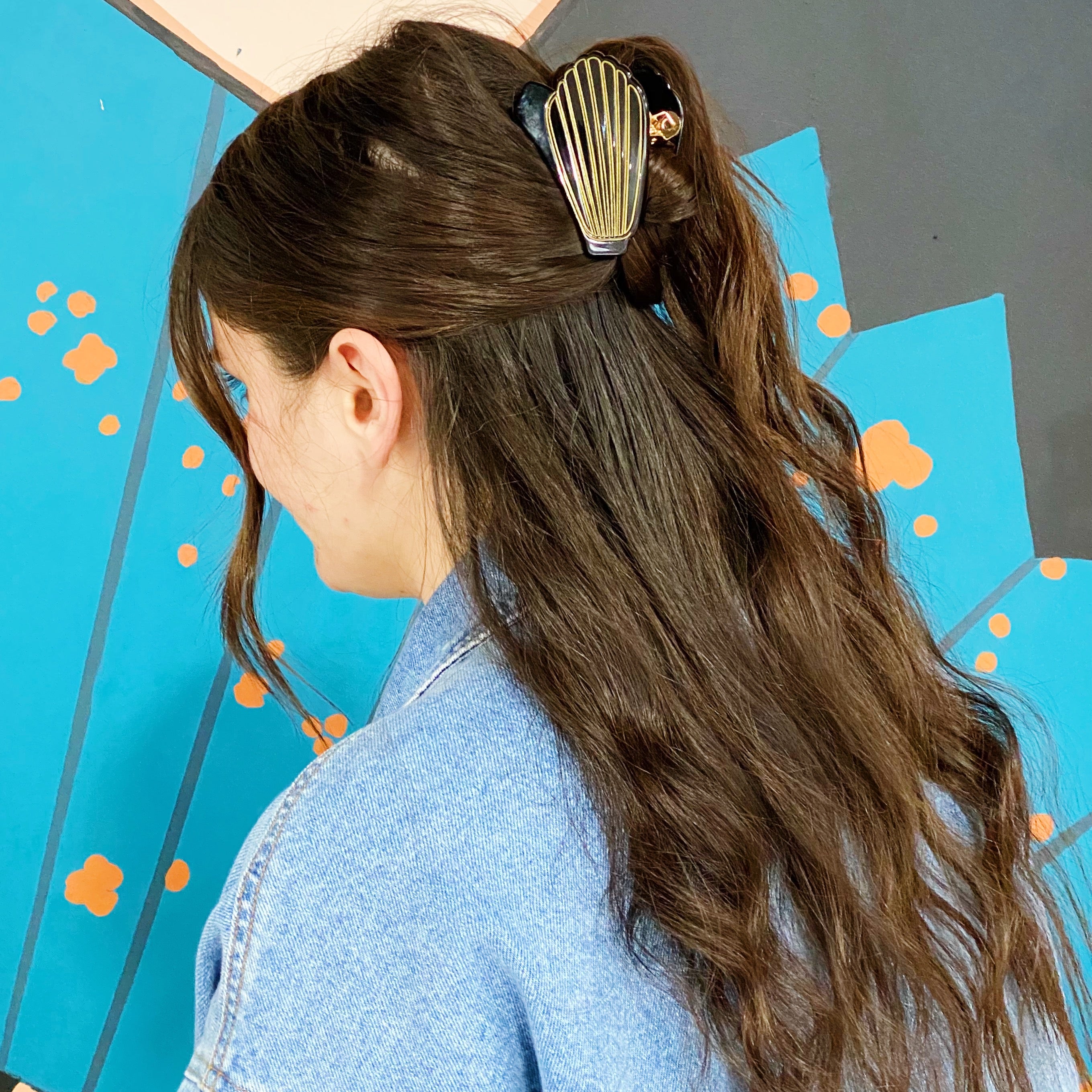 A stylish Mermaid Hair Claw with a shell-like design and gold tone hardware, perfect for summer hairstyles.