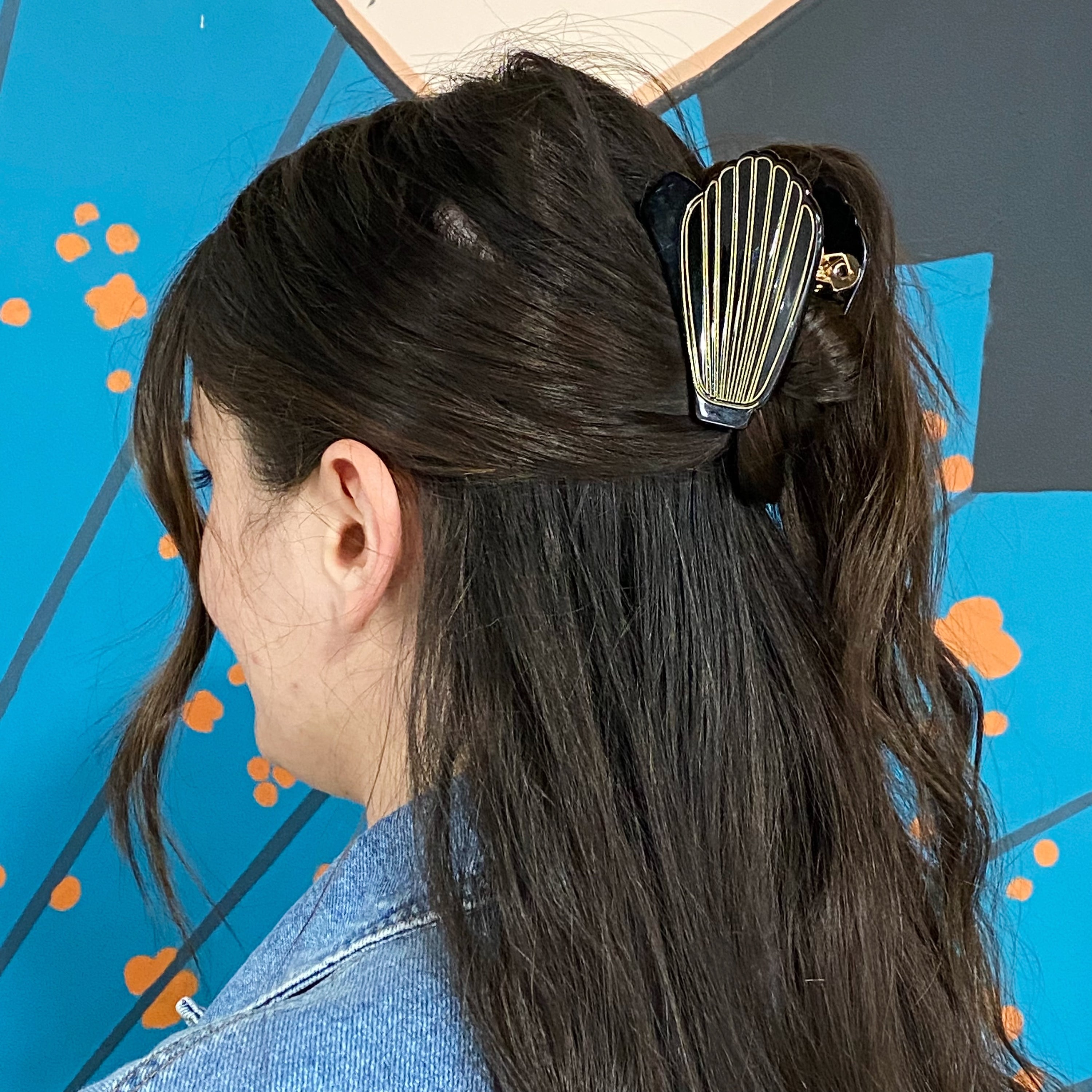 A stylish Mermaid Hair Claw with a shell-like design and gold tone hardware, perfect for summer hairstyles.