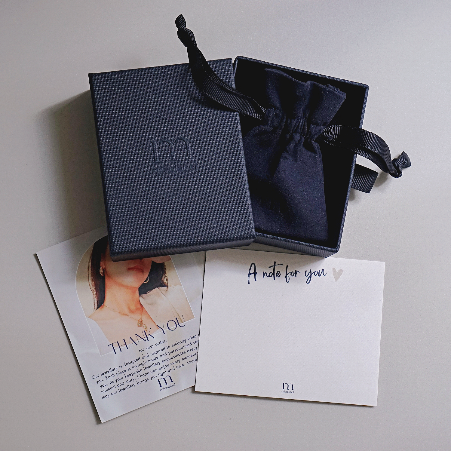 Luxurious navy blue Mienlabel Gift Box with embossed logo, perfect for presenting jewellery elegantly.