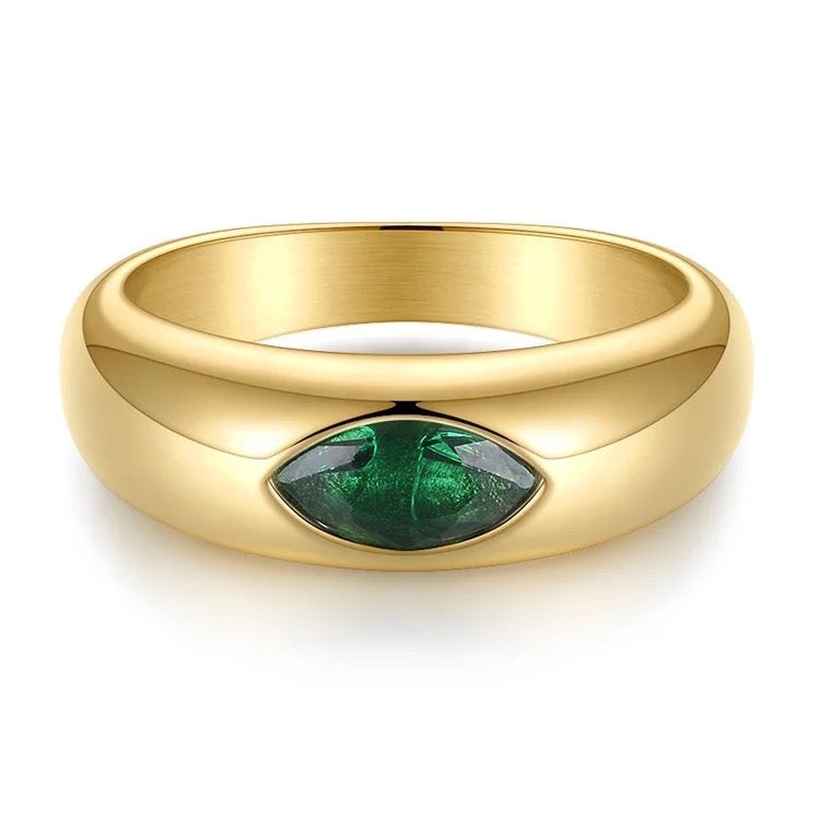 Mila Emerald Ring featuring 18k gold plating and sparkling CZ stones, showcasing a vibrant emerald color and elegant design.