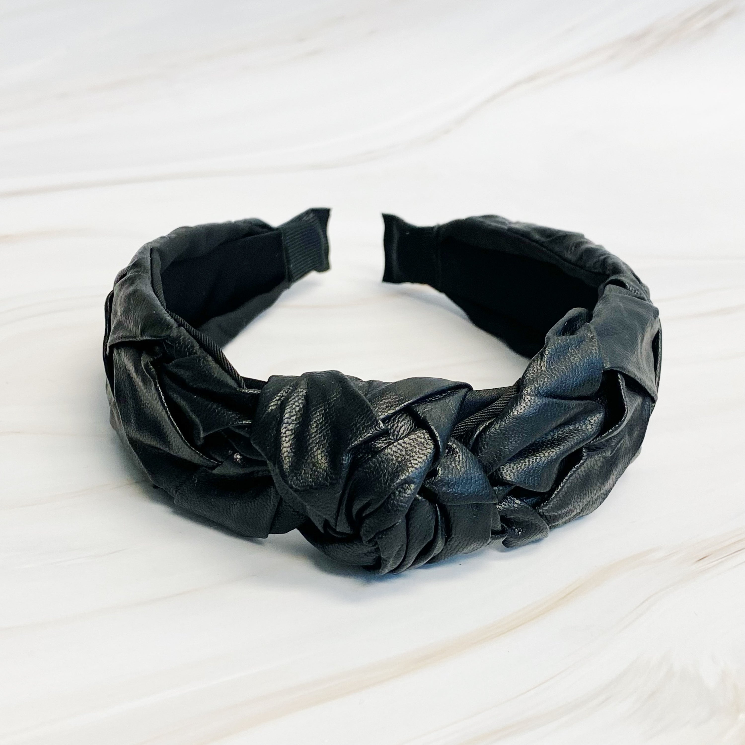 Milano Woven And Knotted Headband featuring a stylish leather woven design and intricate knotted detail.