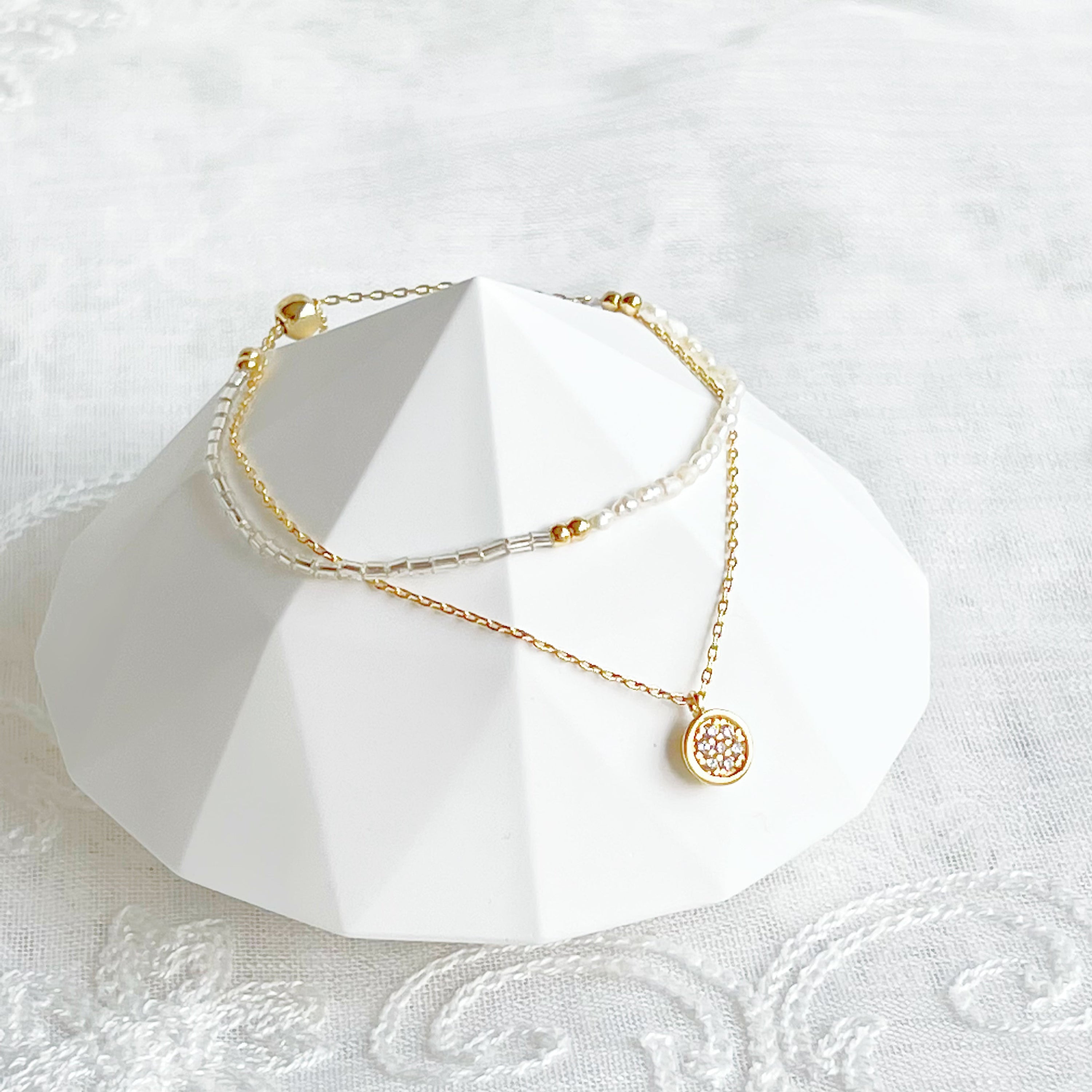 A delicate Mini Baroque Pearls Double Chain Bracelet featuring tiny freshwater baroque pearls and sparkling zircon crystal drops on a gold-plated chain.