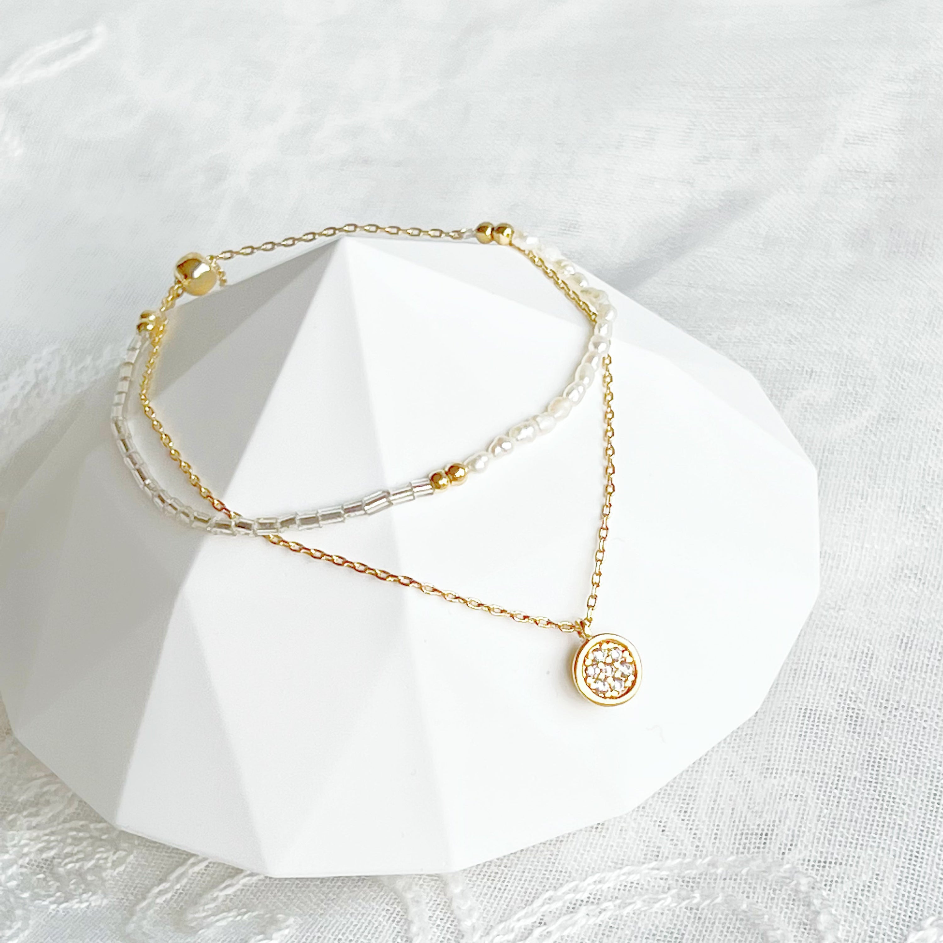 A delicate Mini Baroque Pearls Double Chain Bracelet featuring tiny freshwater baroque pearls and sparkling zircon crystal drops on a gold-plated chain.