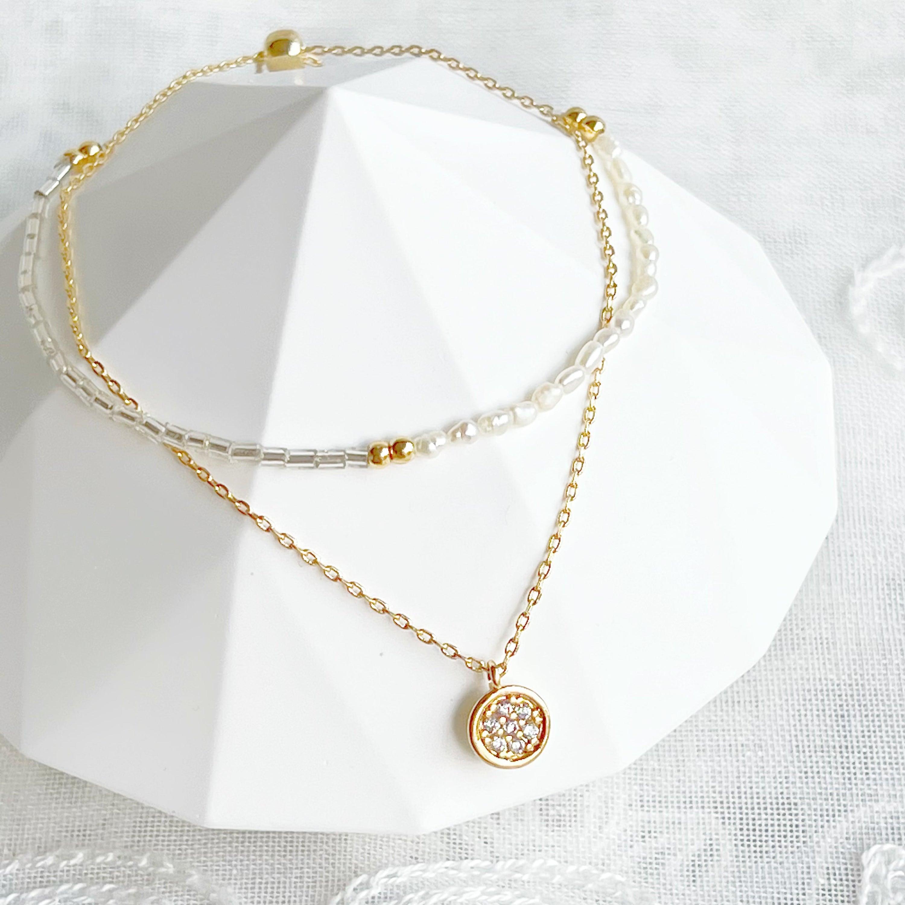 A delicate Mini Baroque Pearls Double Chain Bracelet featuring tiny freshwater baroque pearls and sparkling zircon crystal drops on a gold-plated chain.