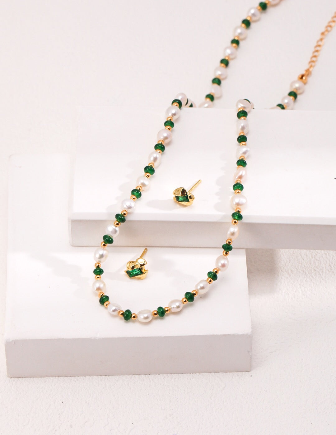 A delicate Mini Emerald Freshwater Pearl Necklace featuring sterling silver and gold vermeil, adorned with emerald stones and irregular freshwater pearls.