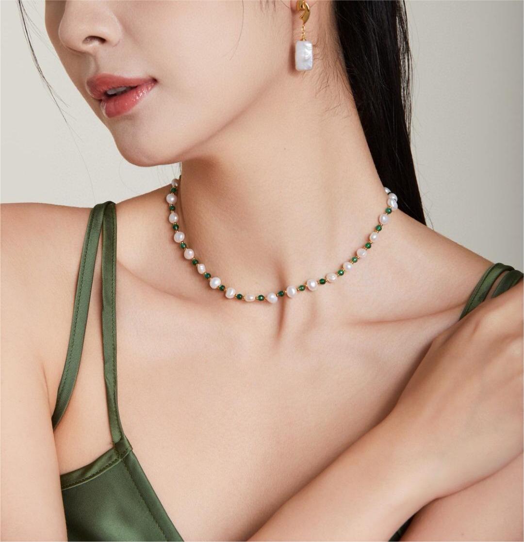 A delicate Mini Emerald Freshwater Pearl Necklace featuring sterling silver and gold vermeil, adorned with emerald stones and irregular freshwater pearls.