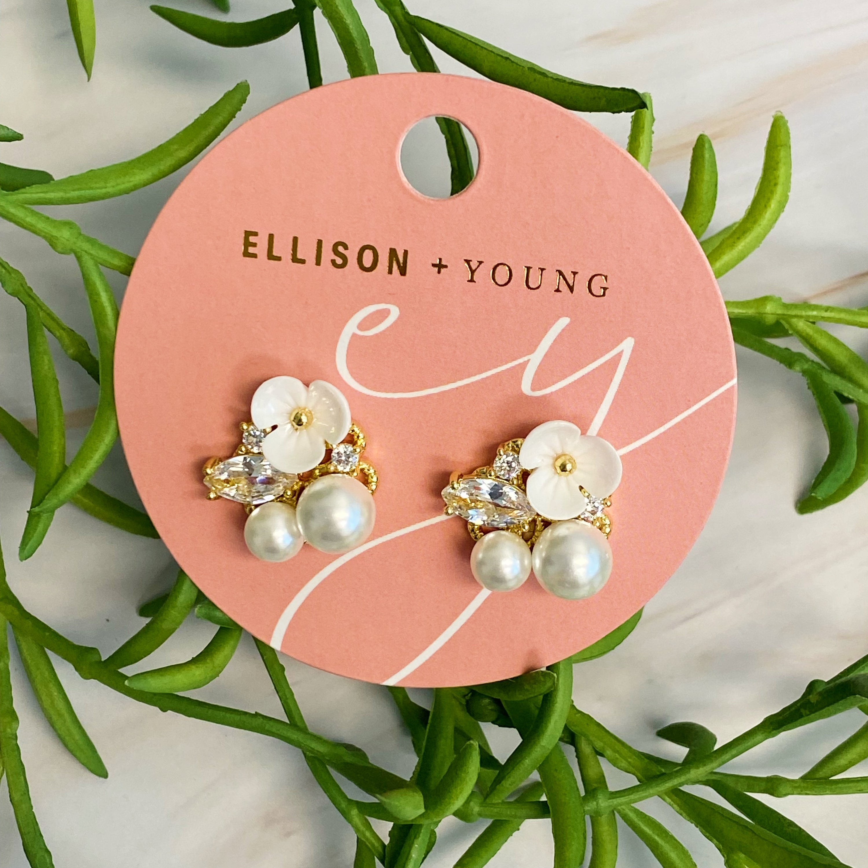 Mini Flower Jeweled Stud Earrings featuring sparkling cubic zirconia and delicate pearl accents on a gold plated brass base.