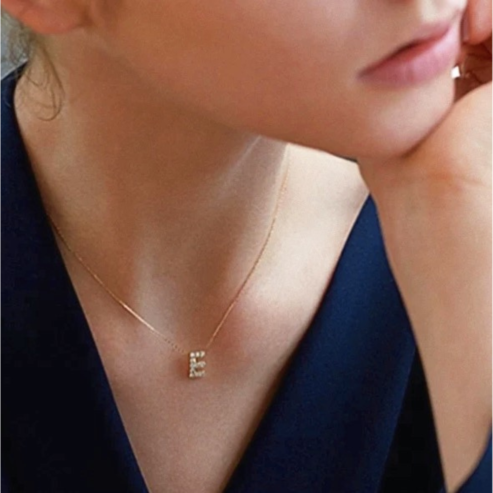 Mini Keepsake Initial Necklace featuring a small initial pendant on a dainty gold plated chain with cubic zirconia accents.